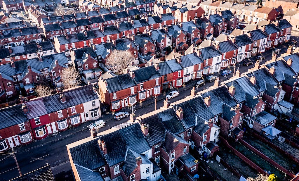 Aerial view of terraced housing in the UK with the sun rising and frost on the rooftops