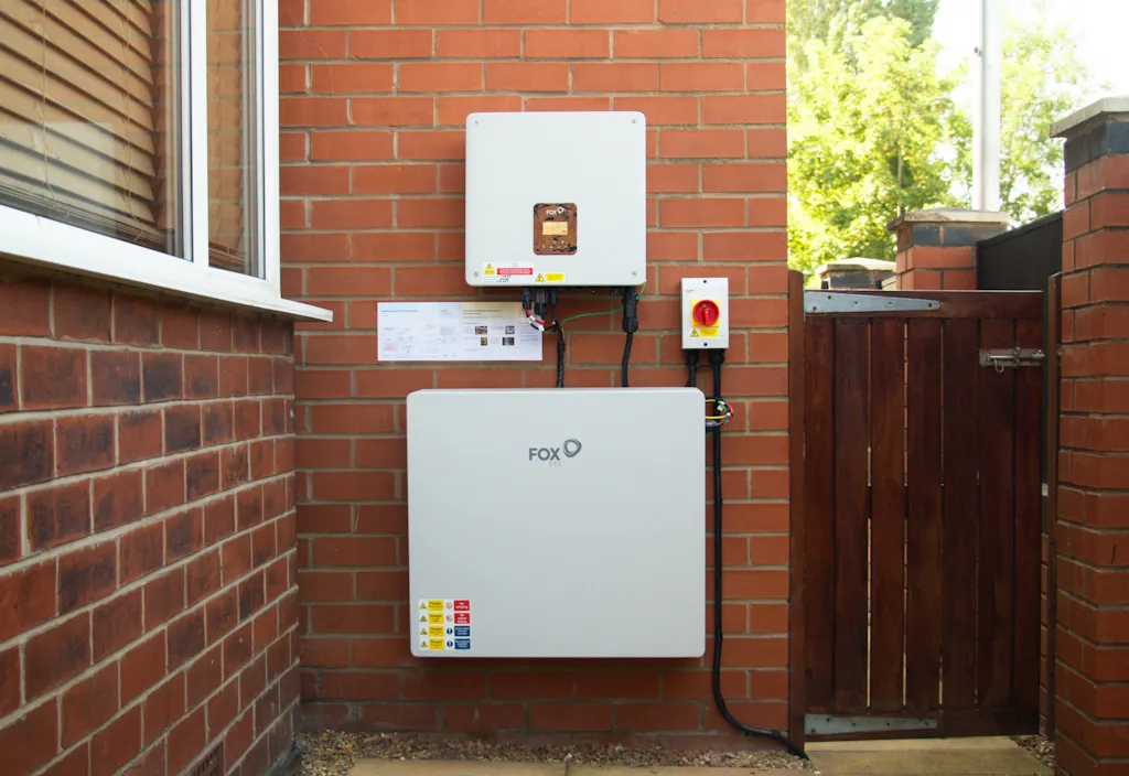 A battery and inverter on a brick wall