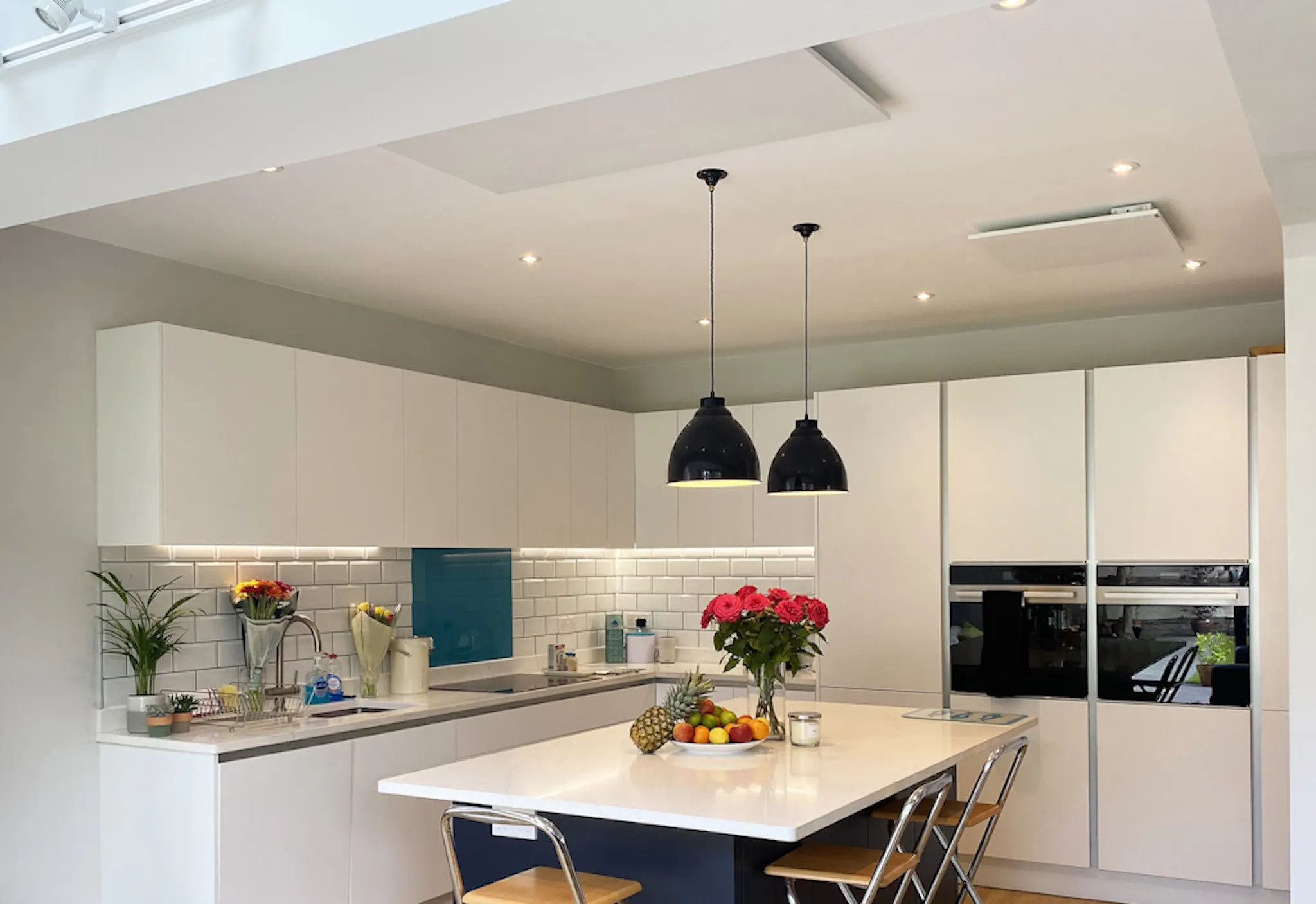 white infrared panels on the ceiling of a mostly white kitchen