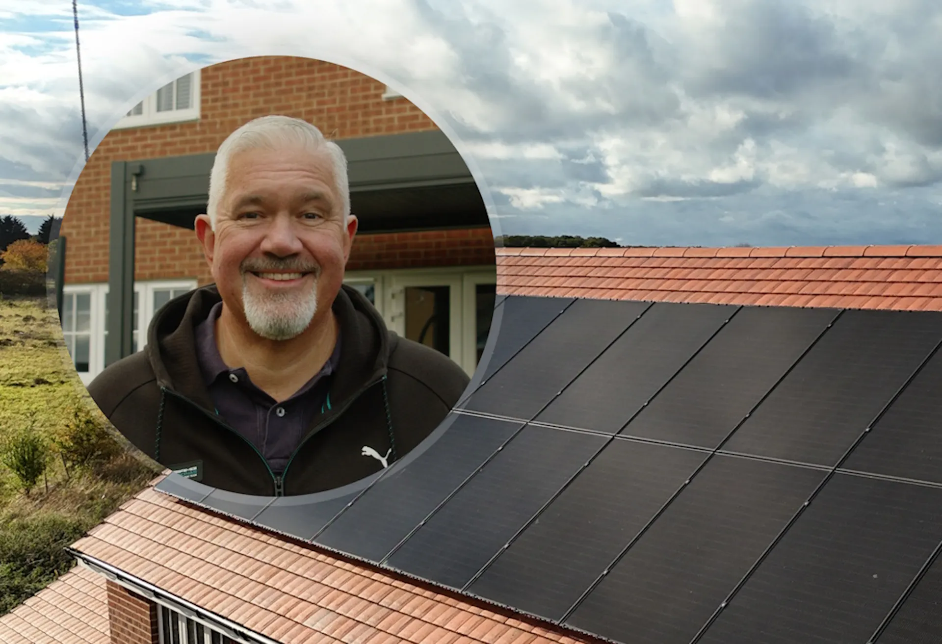 Tony in a circle in front of his roof, which has black solar panels