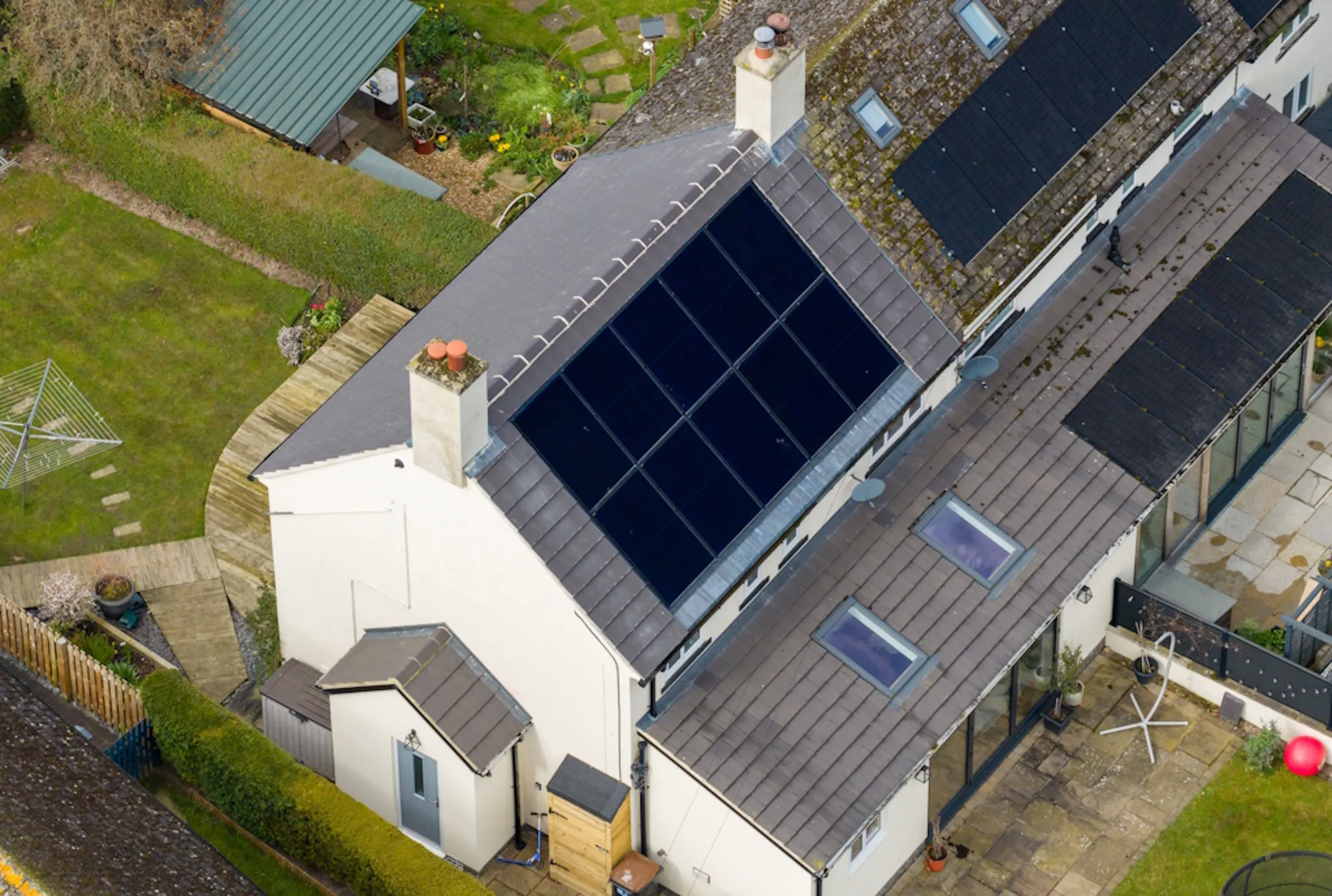 grey and white house with 10 black solar panels 