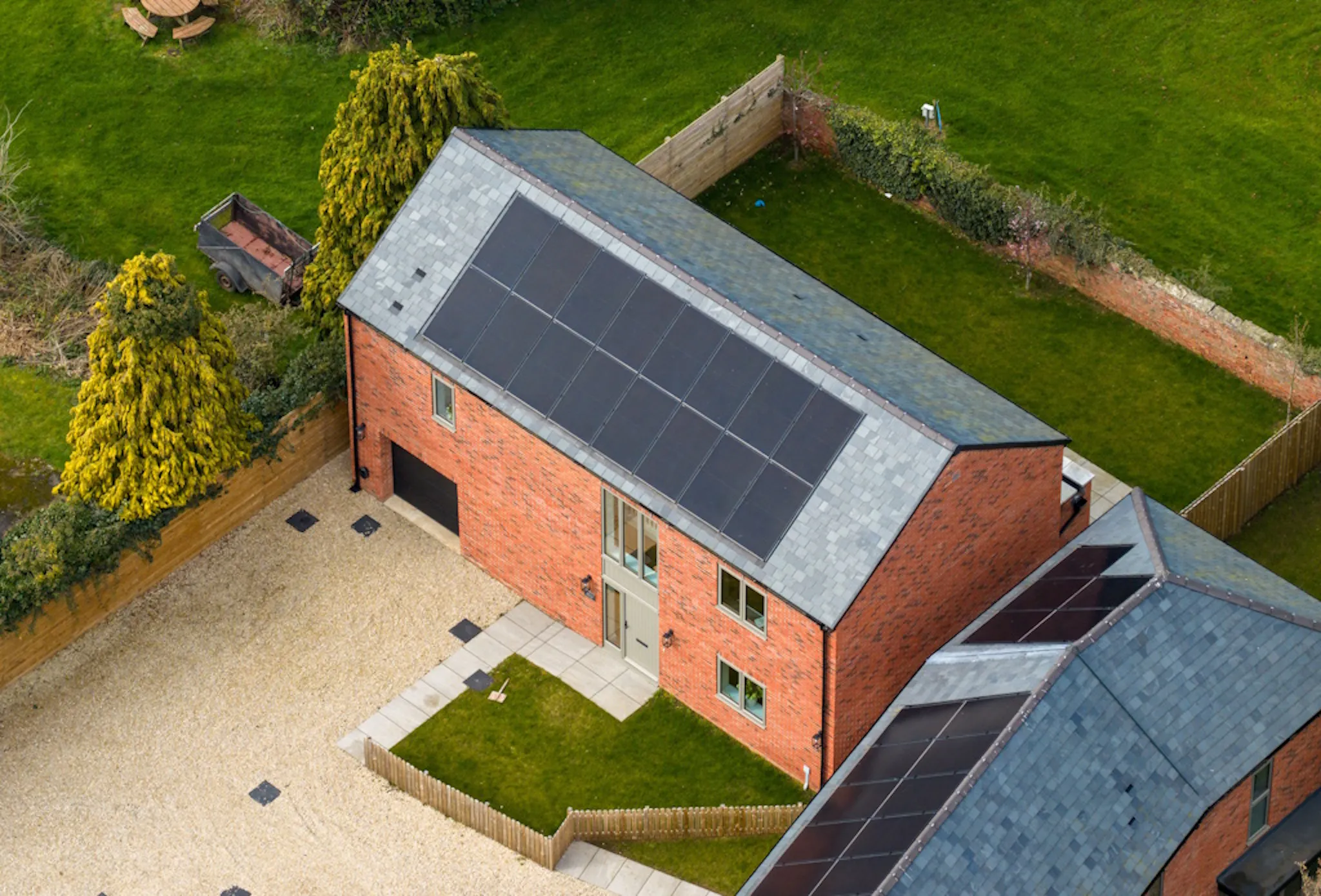 black solar panels on a grey roof, on a brick building