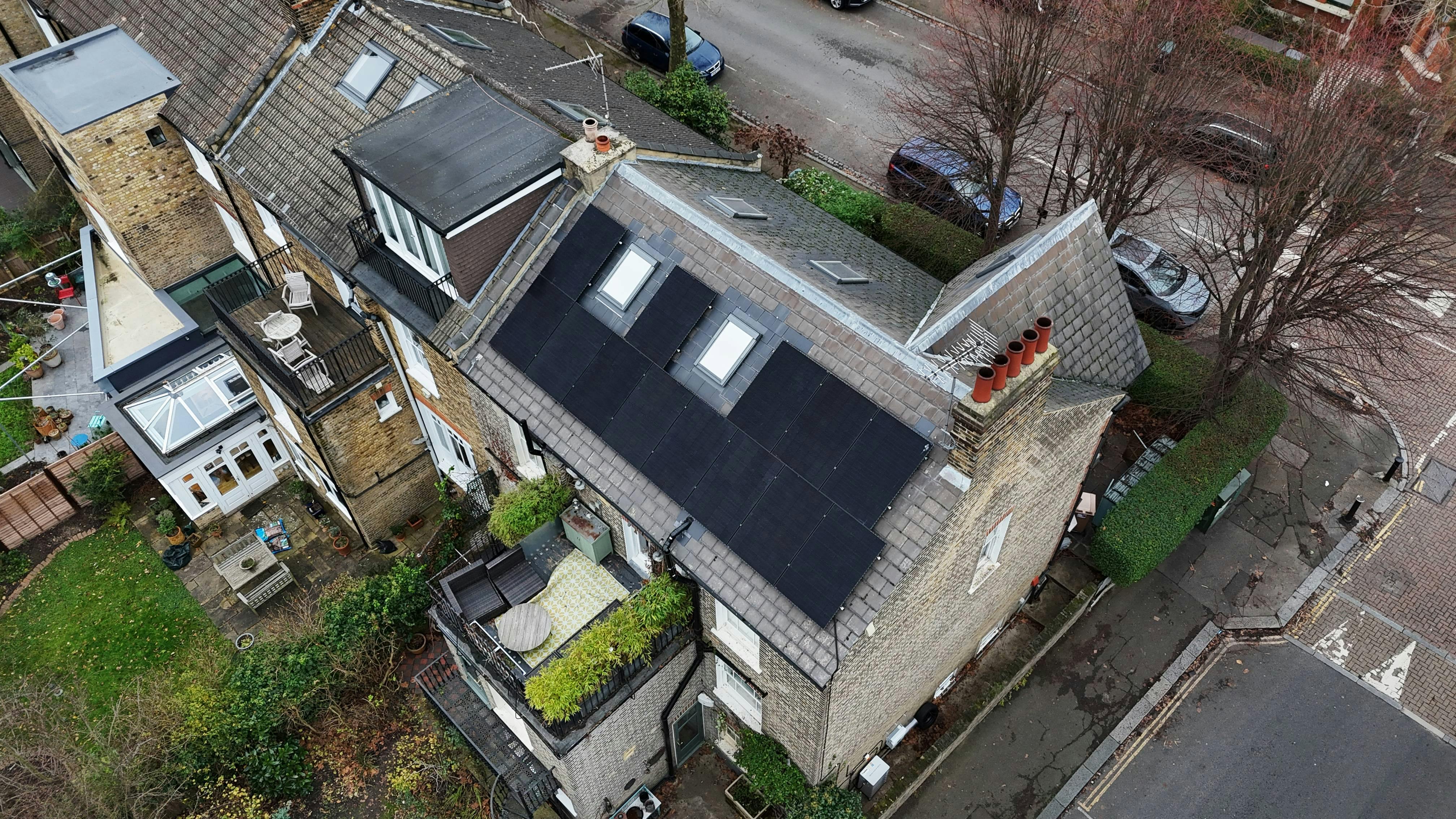 Birdseye view of a black solar panel system on a rooftop in London