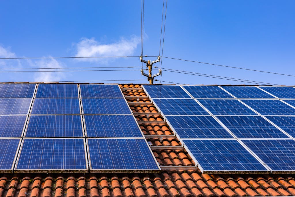 blue solar panels on a terracotta-tiled roof