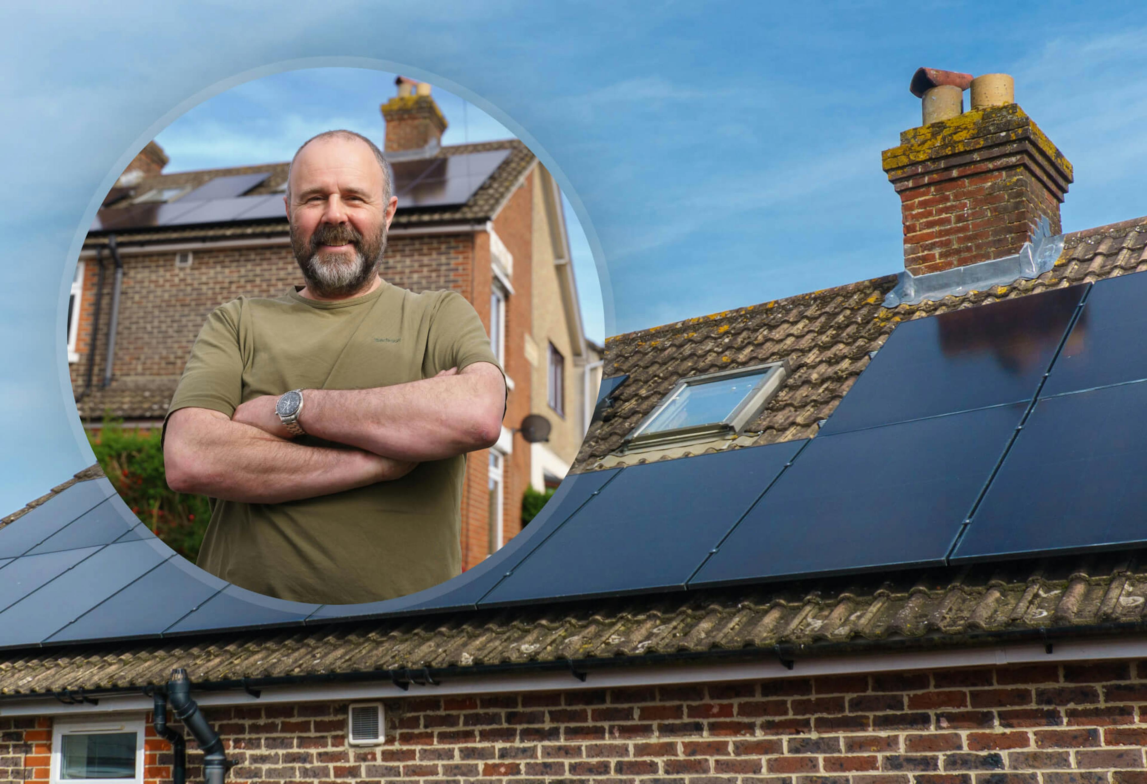 Circle including a man in a green t-shirt with his arms crossed, against a background of a house with a roof with black solar panels and a chimney