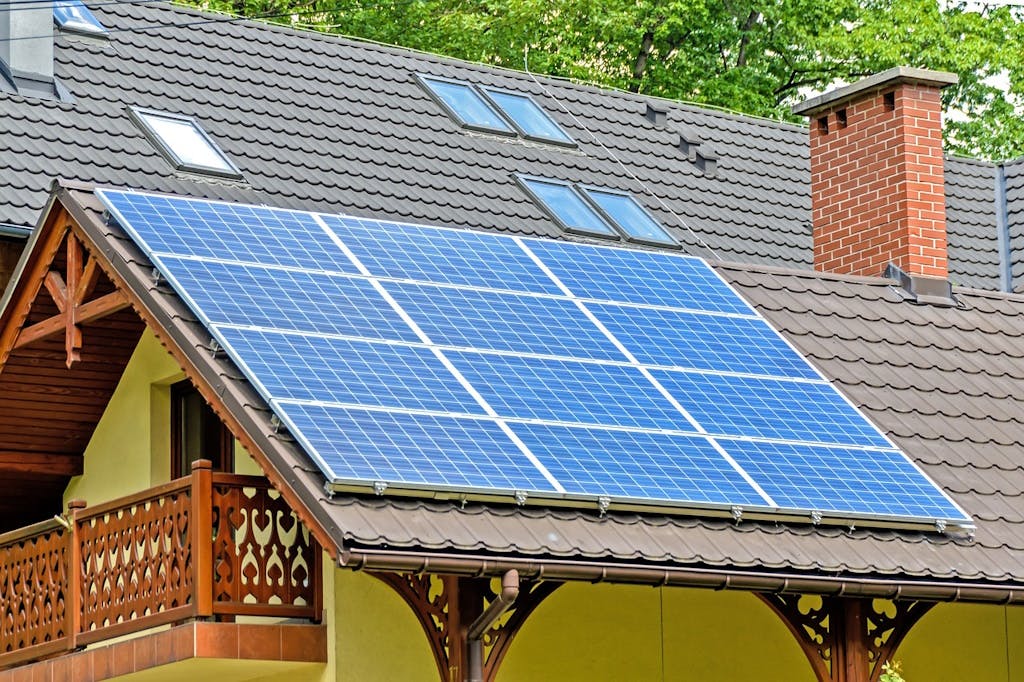 blue solar panels on a brown roof of a home