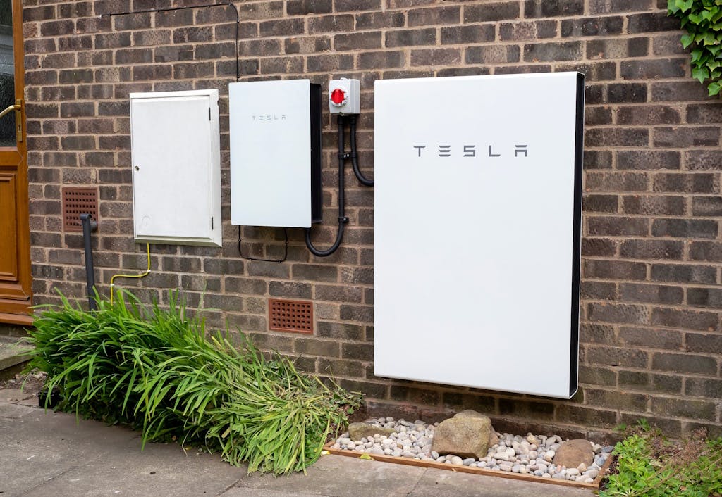 a Tesla Powerwall battery on a brick wall of a home in York, UK