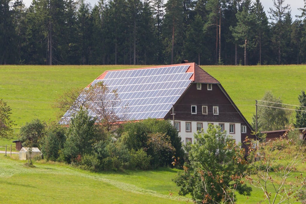A large house in the Black Forest with black solar panels covering the roof
