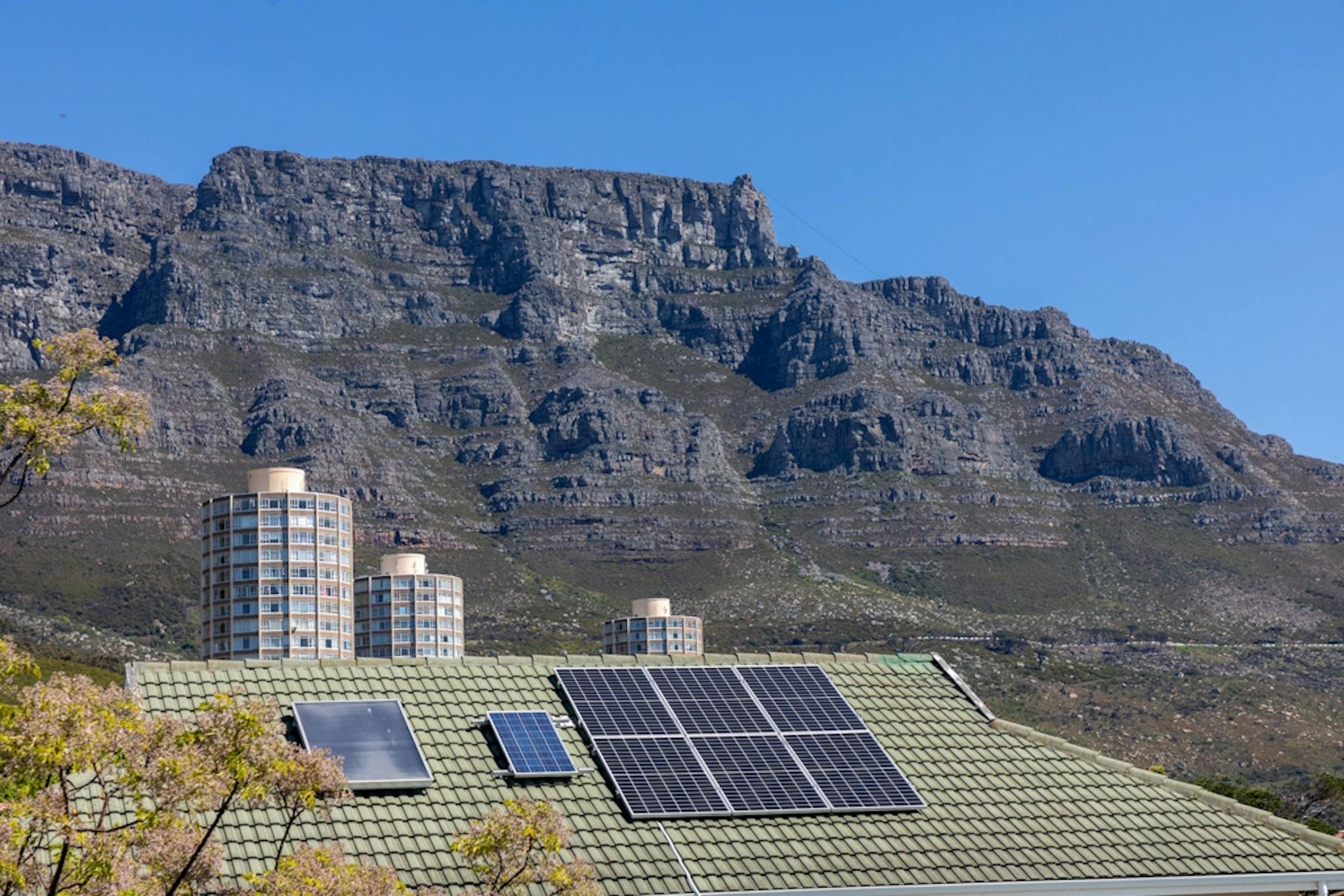 A house with solar panels in Cape Town, with Table Mountain in the background
