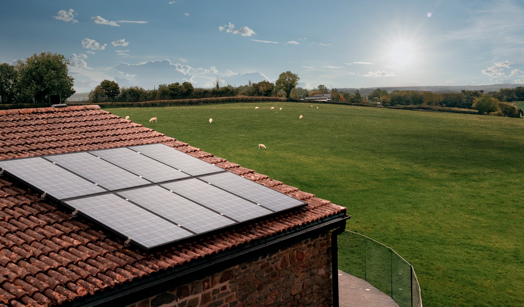 hive hero with solar panels on a roof and field with sheeps in the background image