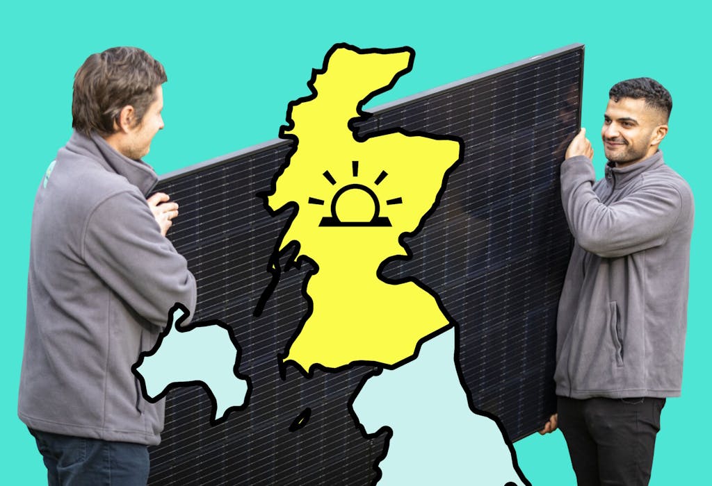 Two people in grey hoodies, holding a black solar panel with a yellow map of Scotland imposed over it