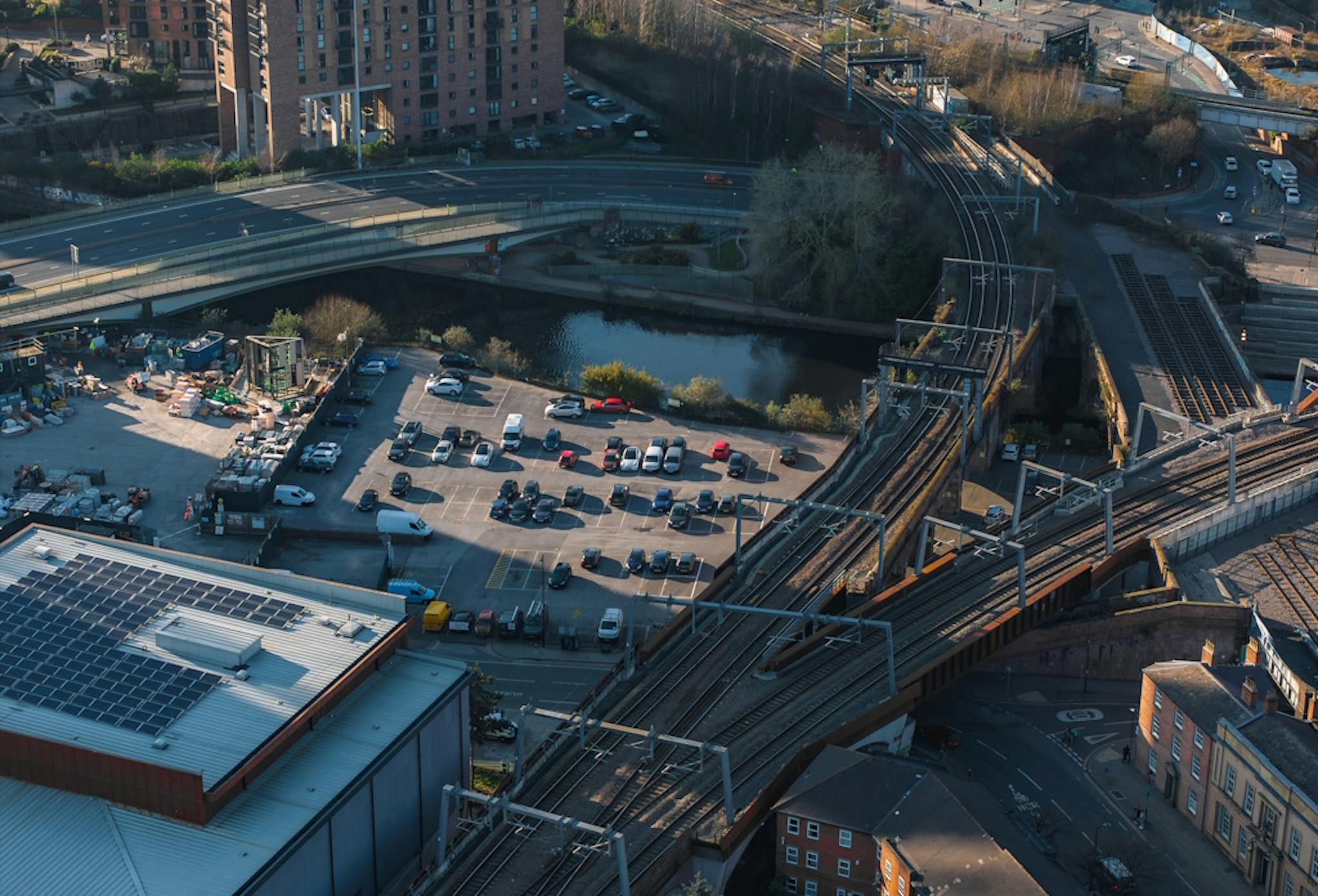 a motorway with cars and a solar panel system on a roof