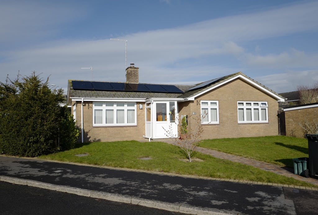 solar panels on a brown bungalow