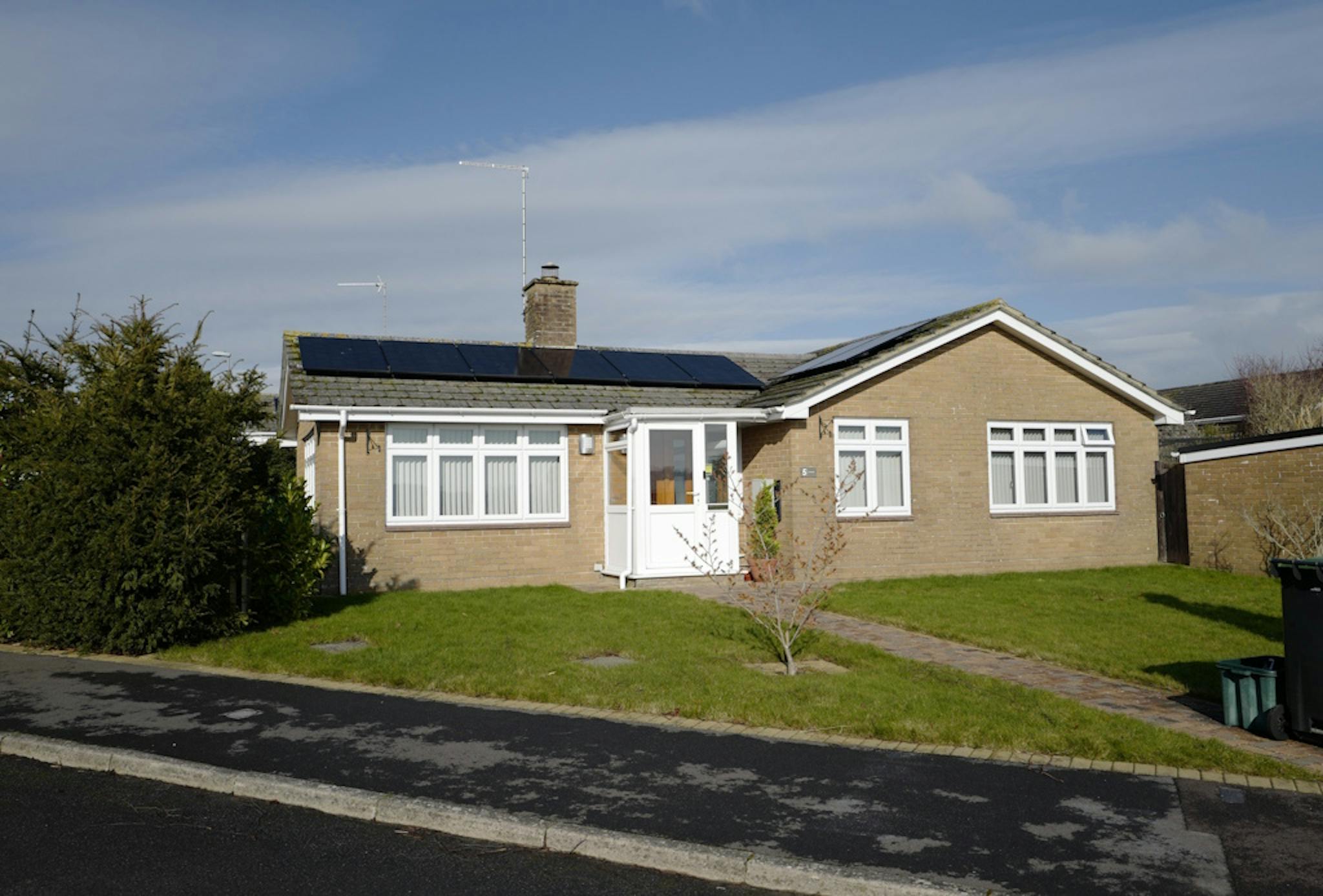 solar panels on a brown bungalow