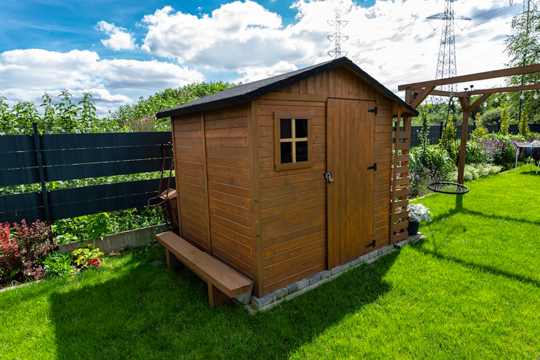 a shed in a garden, under a sky
