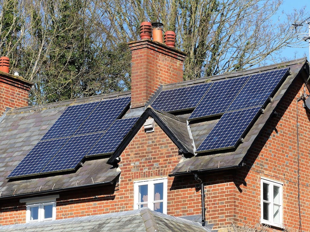 A nine-panel solar PV array on a residential rooftop in the UK