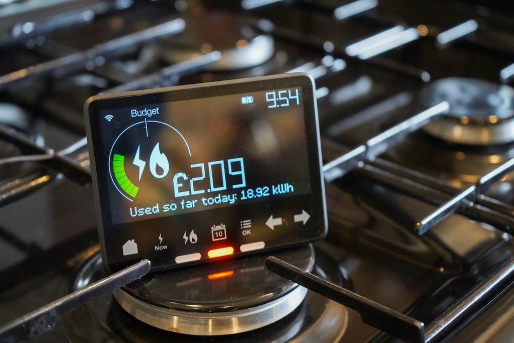 A smart meter on top of a gas hob in a UK kitchen