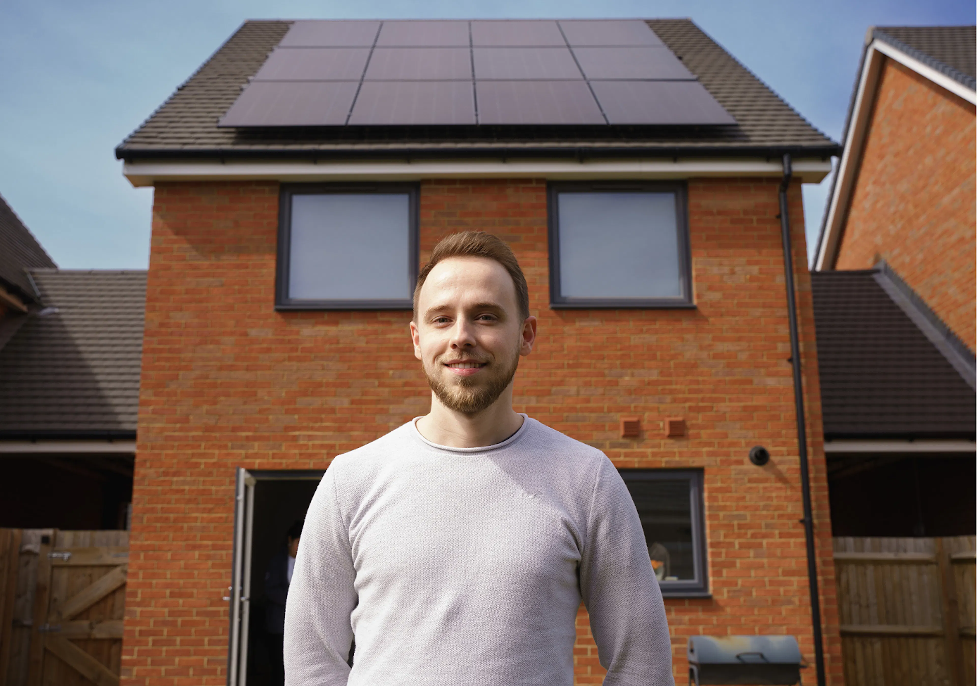 Customer in front of solar panels