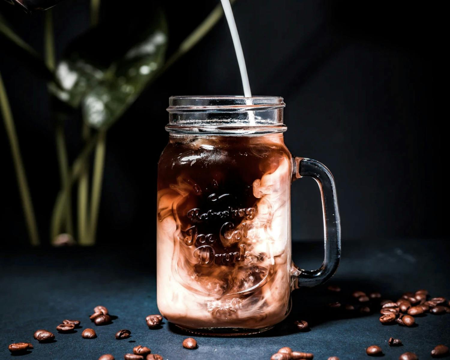 Milk being poured into coffee