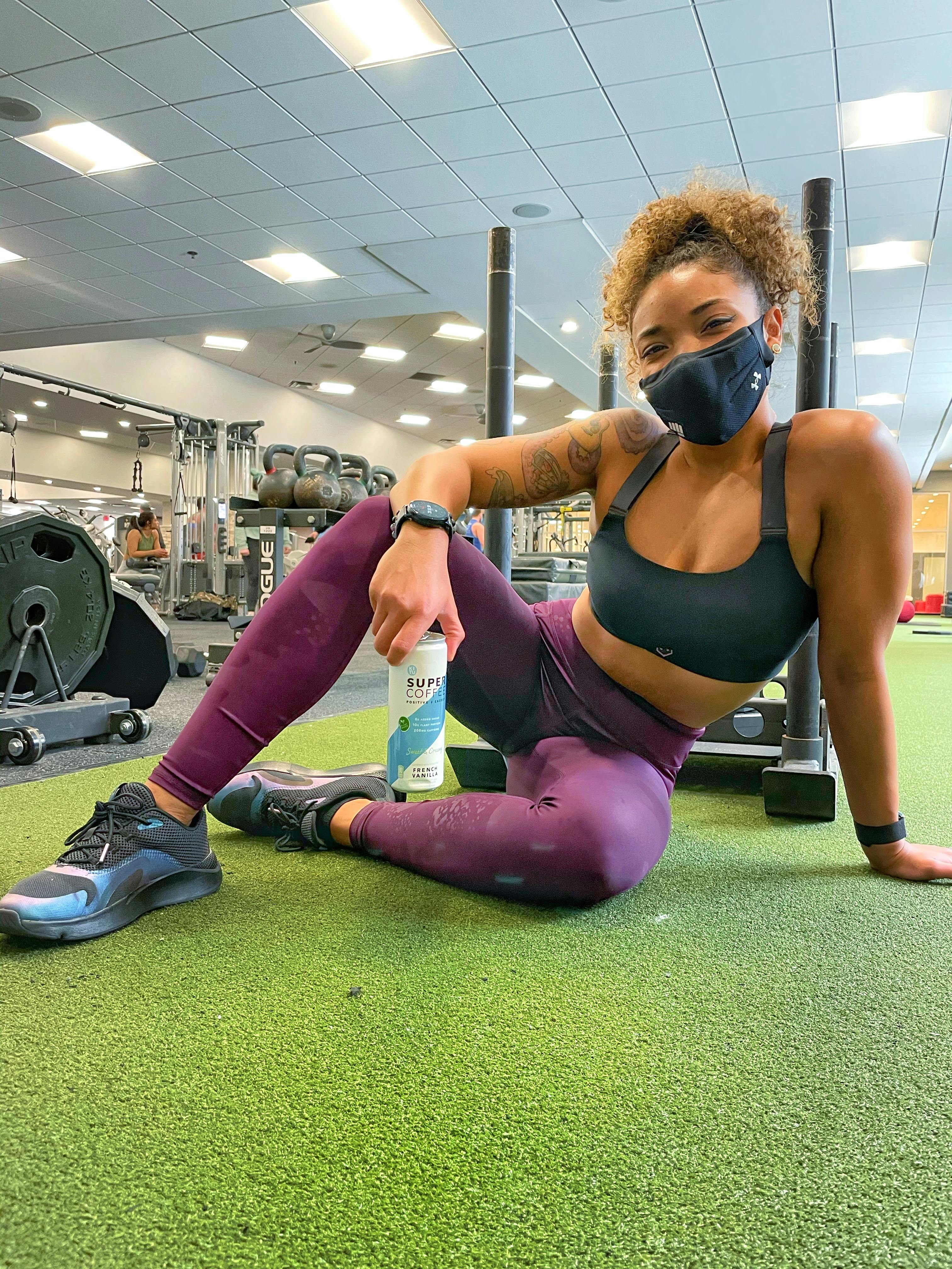 Monica at the gym with a French Vanilla Super Coffee.