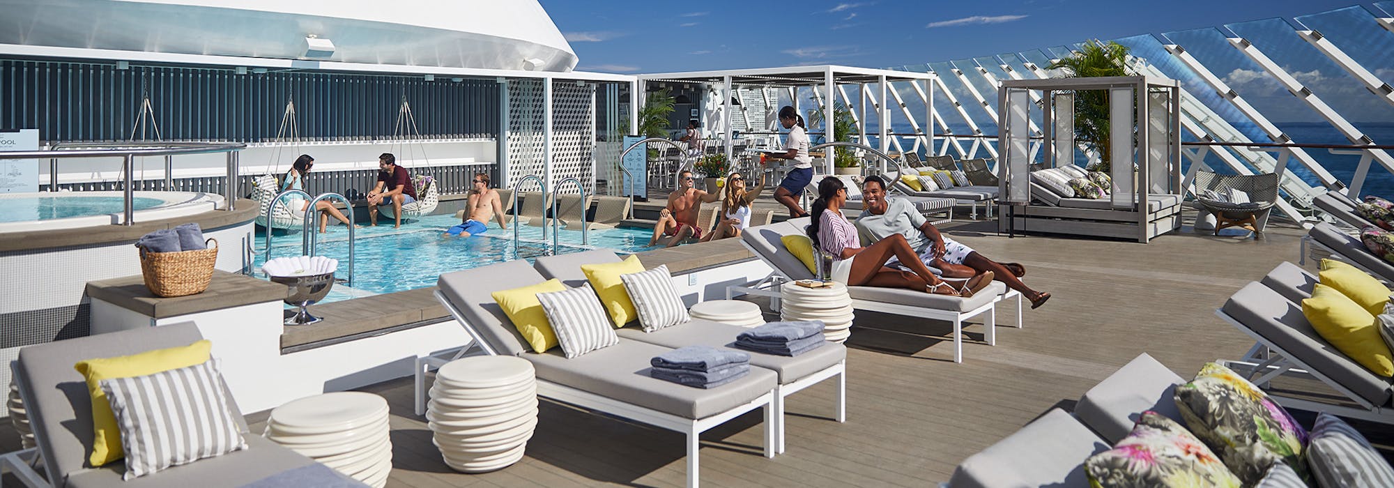 Soldäcket på Celebrity Apex med fler människor i solstolar och en pool till vänster.