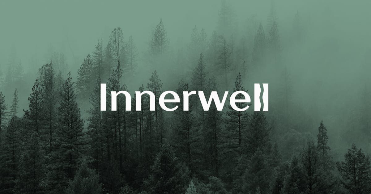 Innerwell logo over a foggy forest