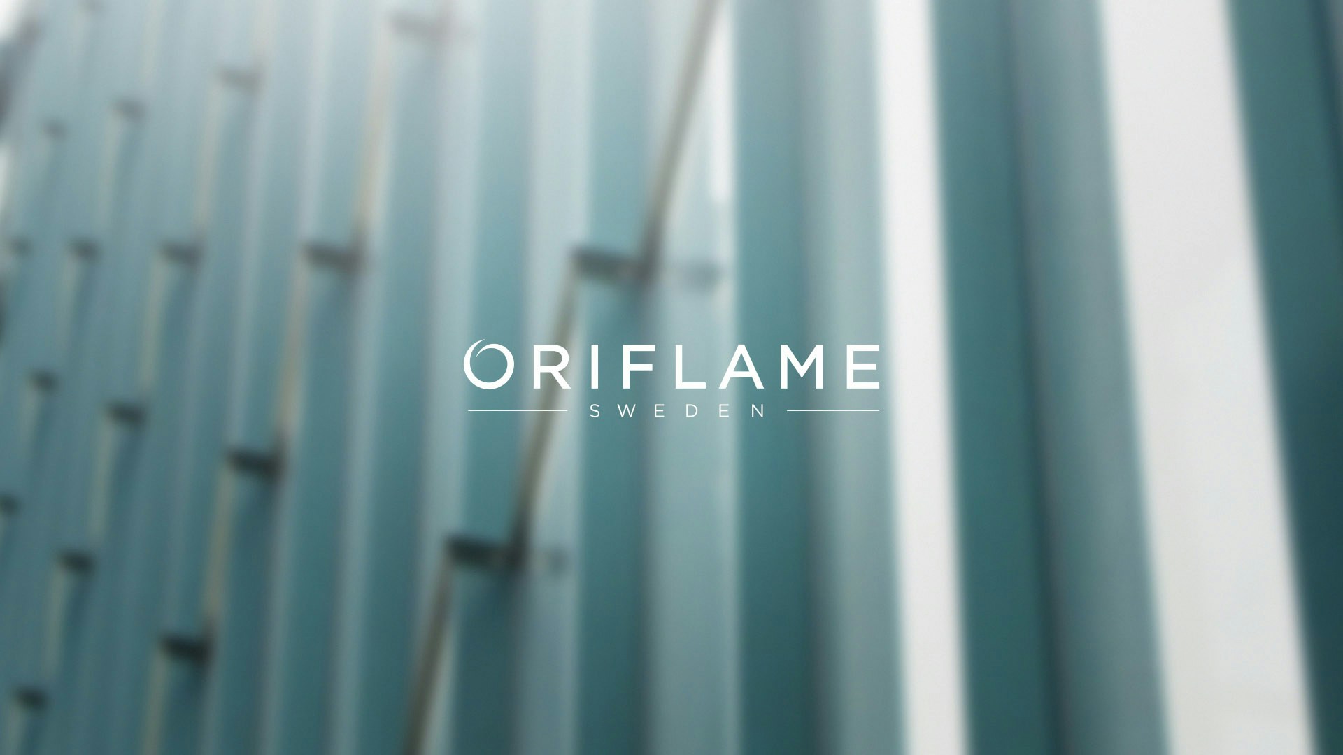 Oriflame logo with depth of field building in the background.