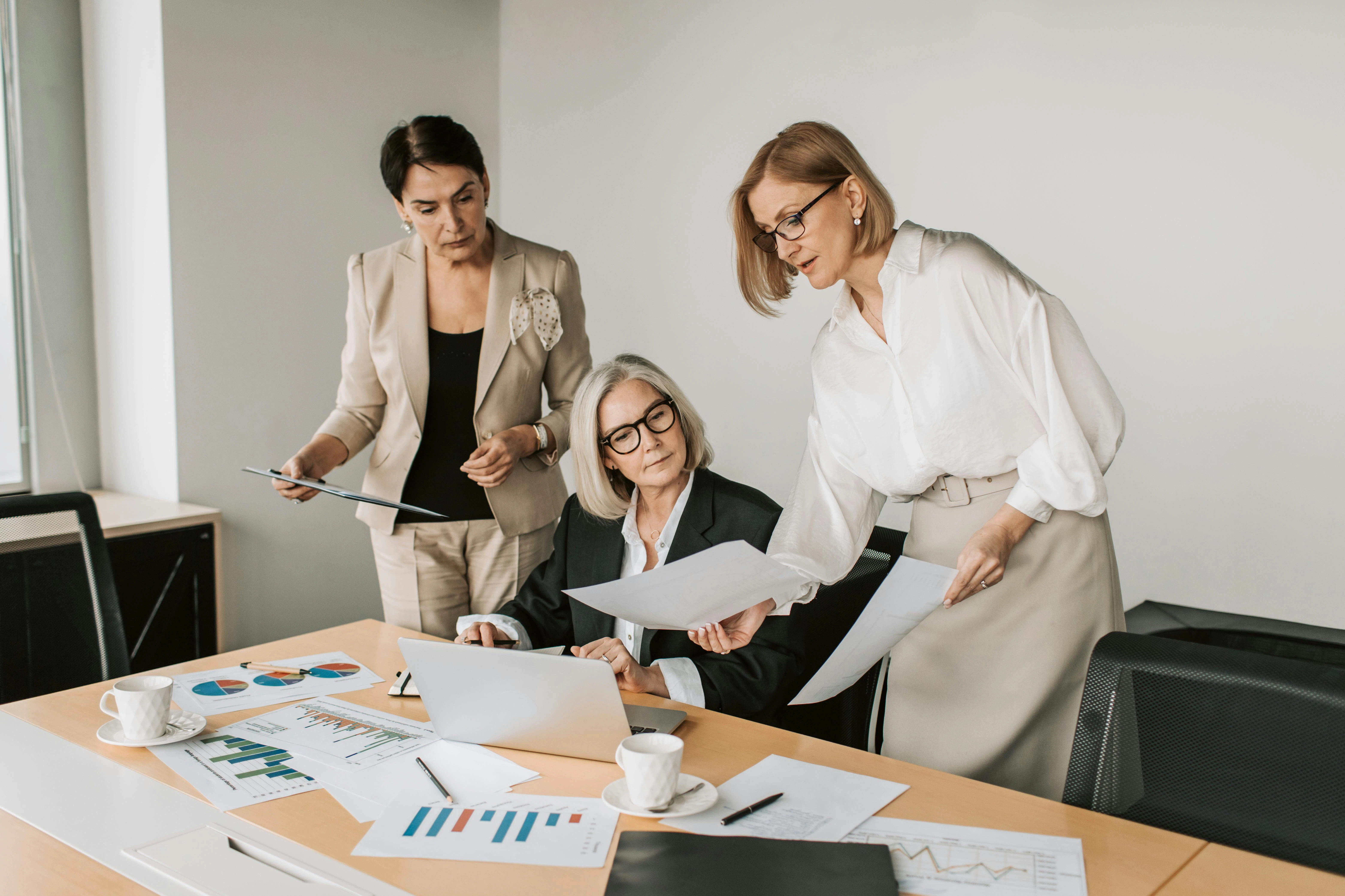 Nordic HR professionals reviewing charts and documents in a meeting