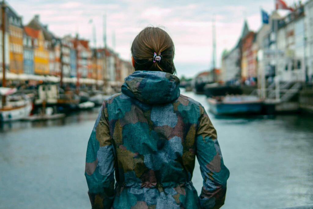 Woman overlooking buildings along a river