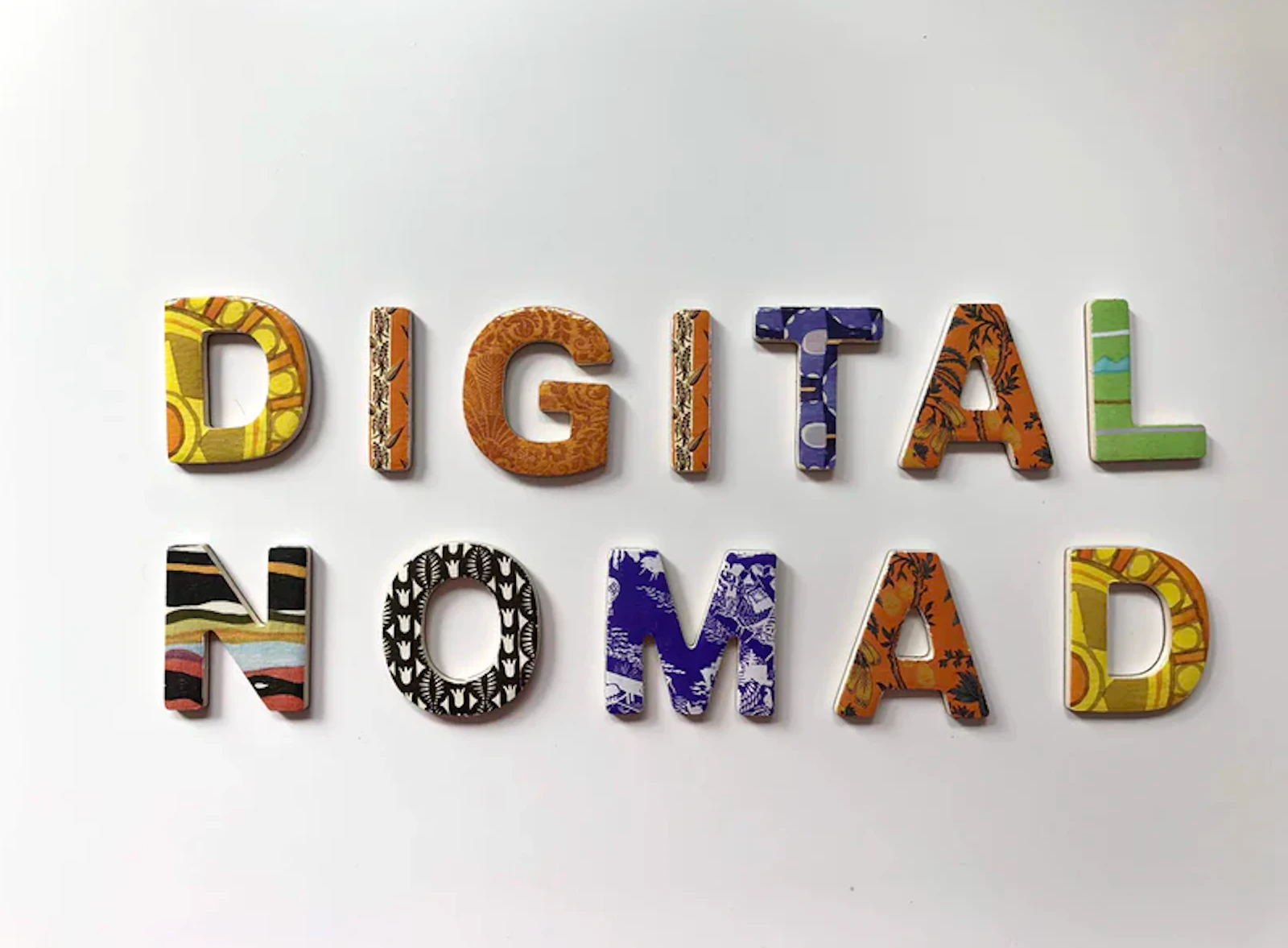 Colorful decorative lettering spelling out "Digital Nomad" on a light background.