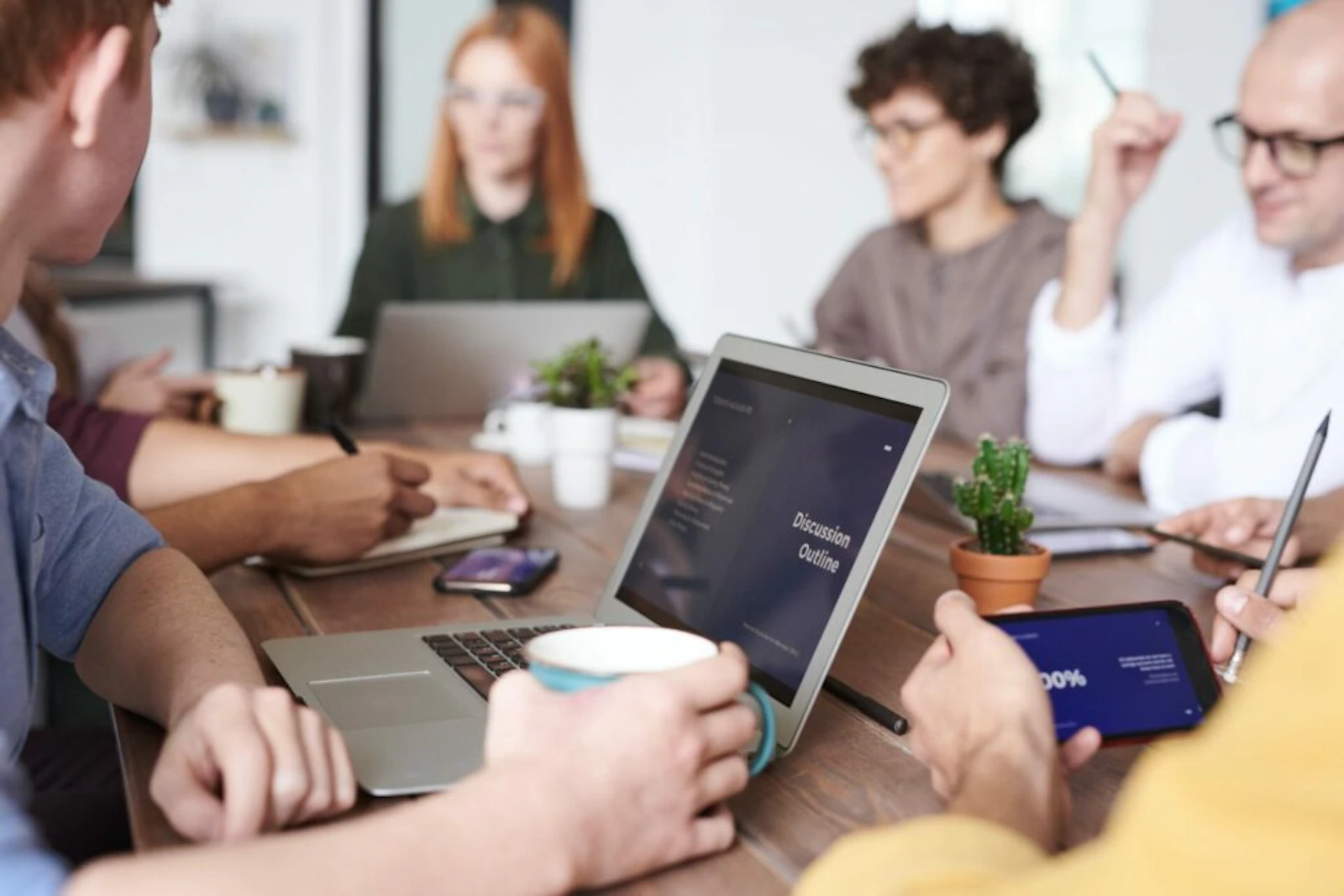 a small team of colleagues working in a modern conference room