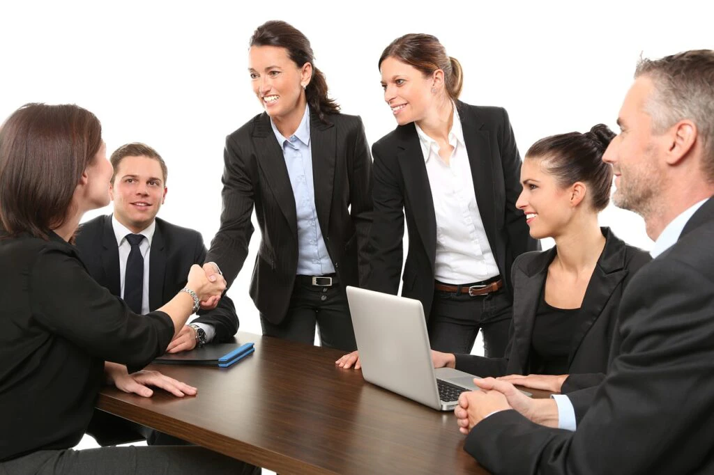 Team of business professionals closing a deal at a conference table