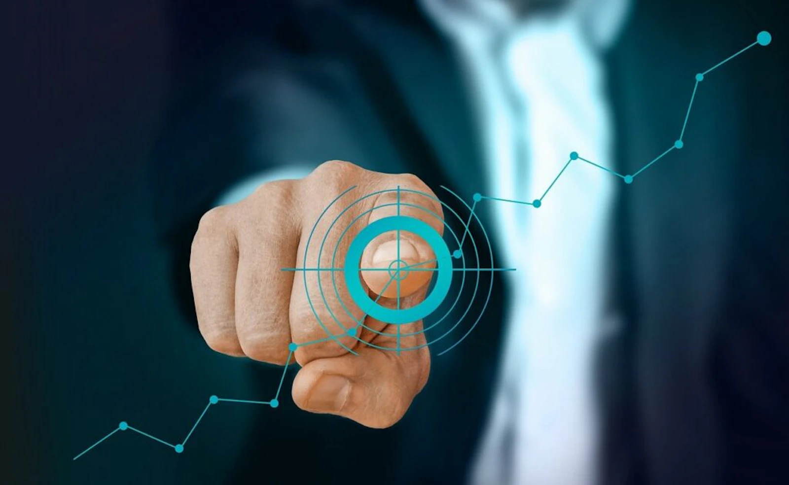 Businessman pressing a digital target bullseye with analytics trend lines representing business goals