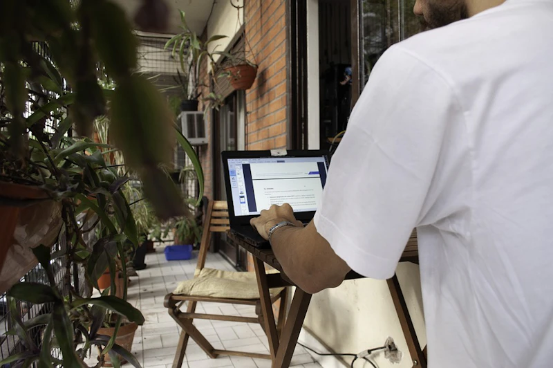 Person working on his laptop in a modern office environment.