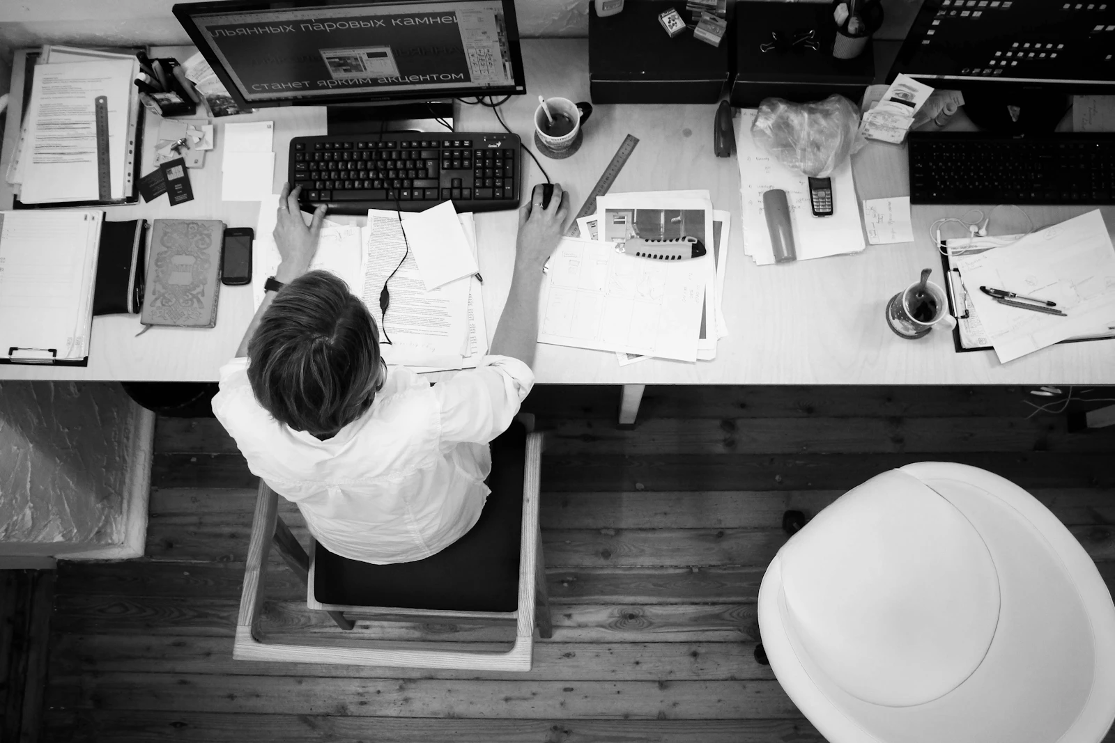 aerial view of a person working in an office in black and white