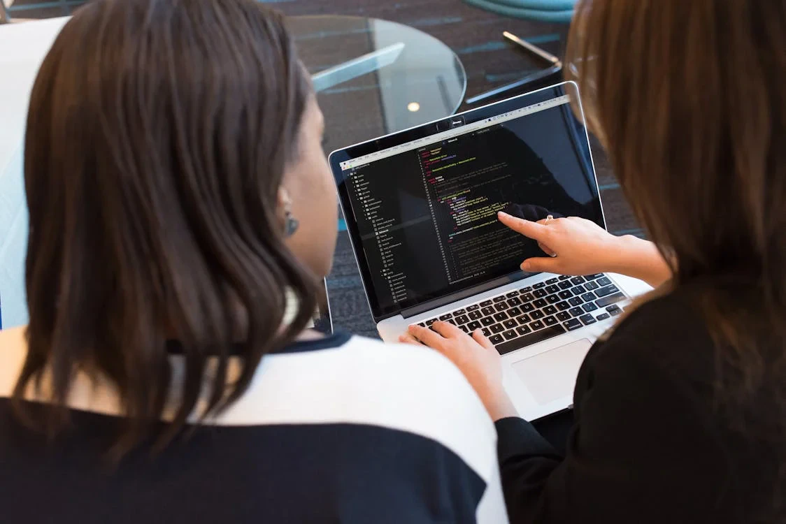Software developers discussing code