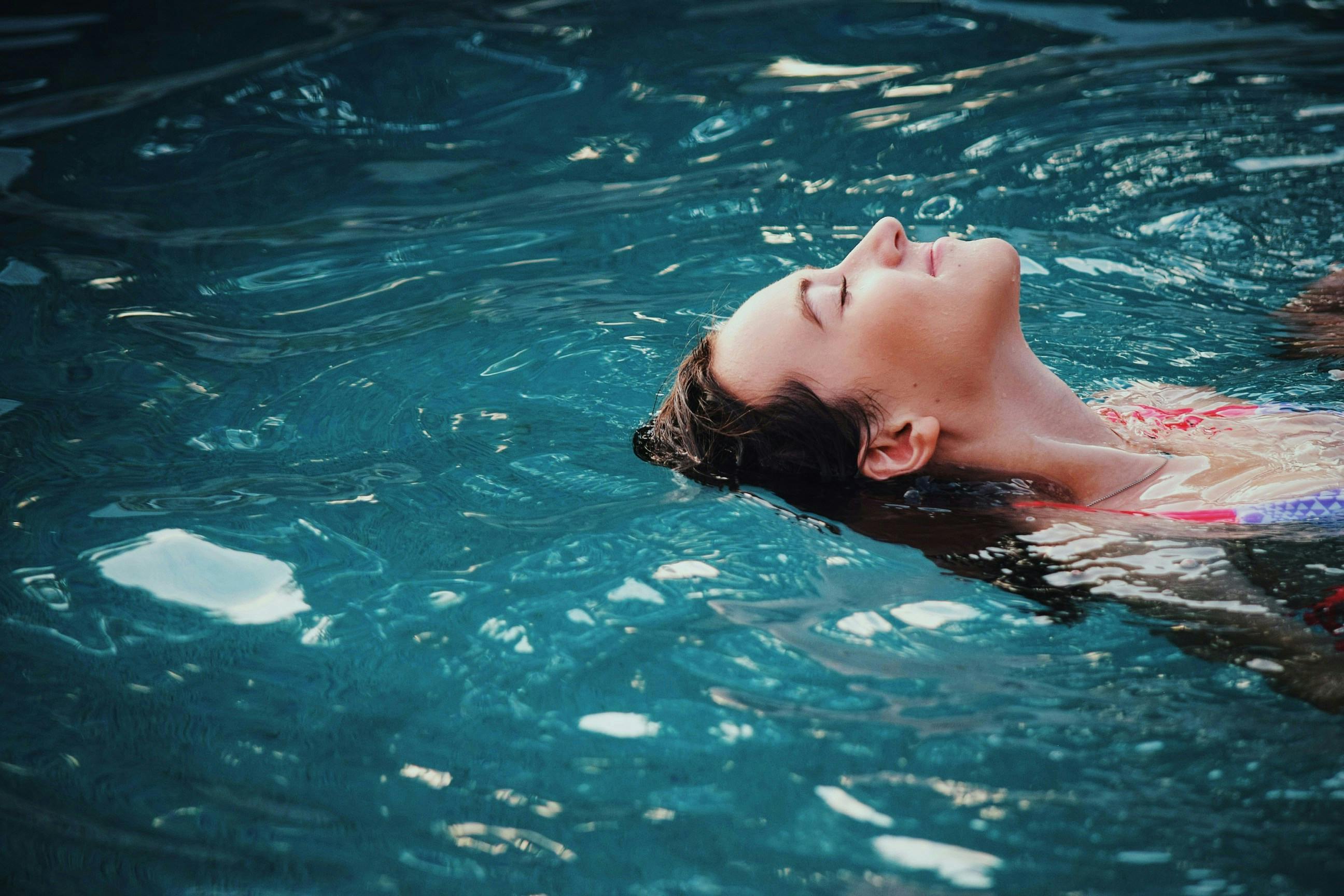 Woman Smiling While Floating In Water