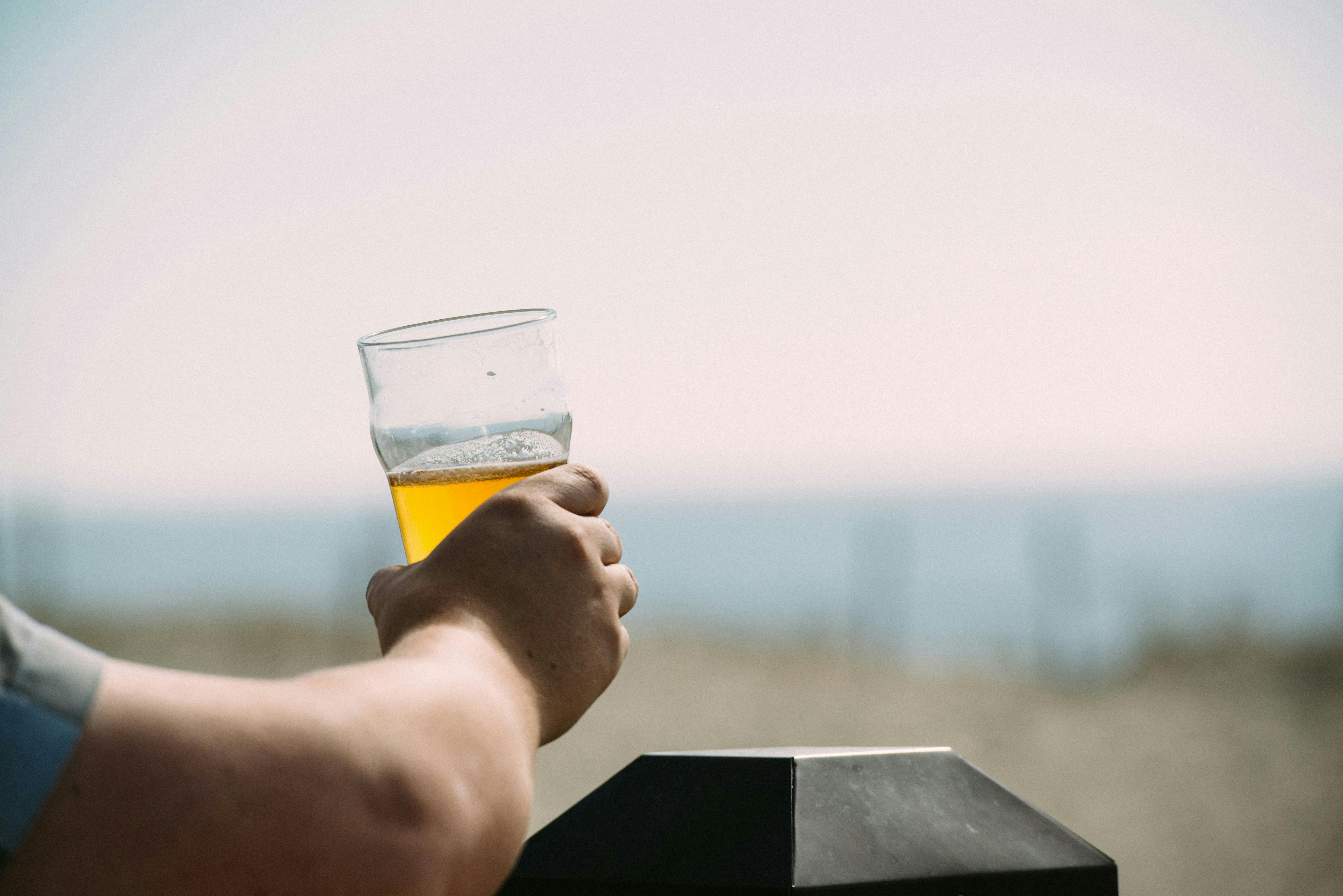 Man holding a beverage in his right hand