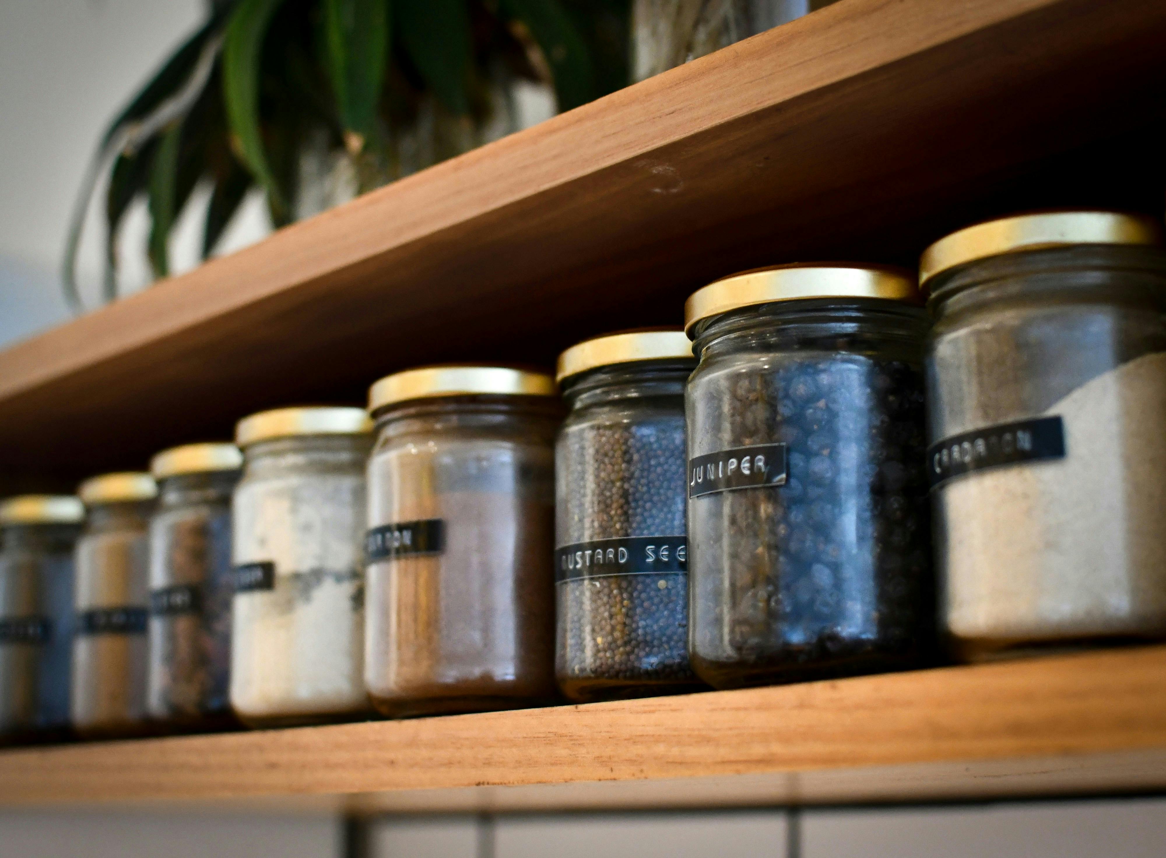 Glass jars lined up on a shelf