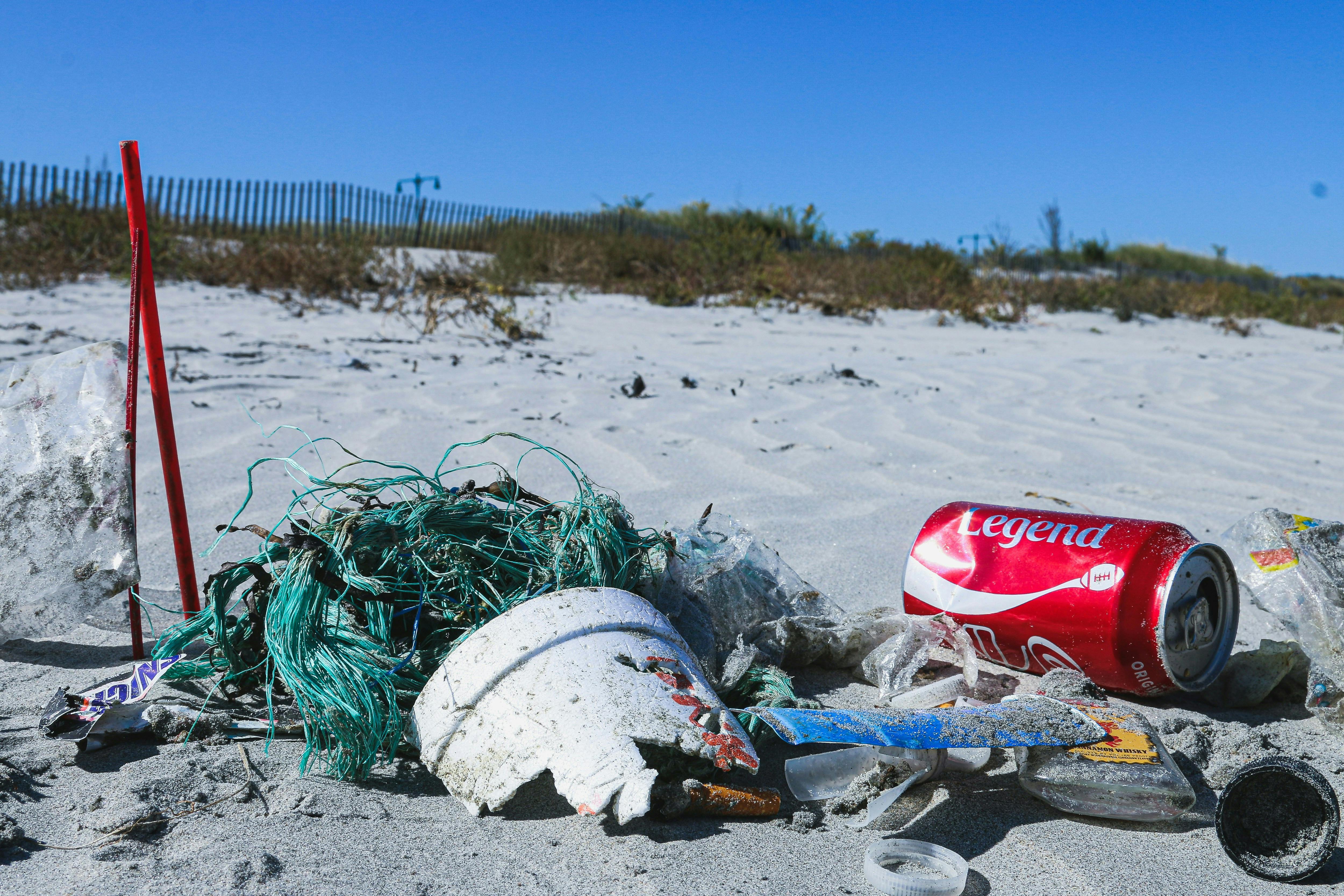 Plastic trash laying on a sandy beach
