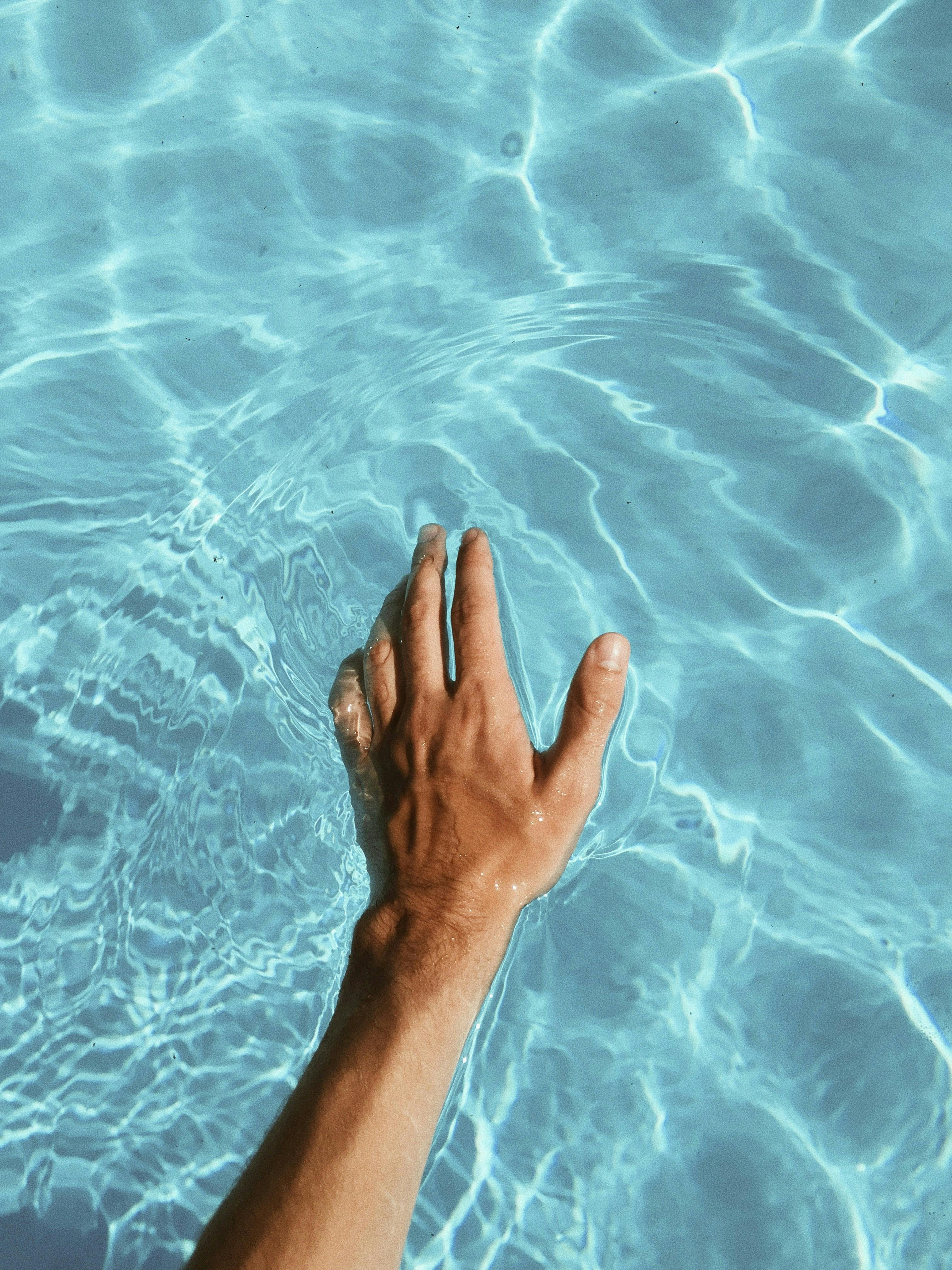 Hand floating on turquoise blue waters