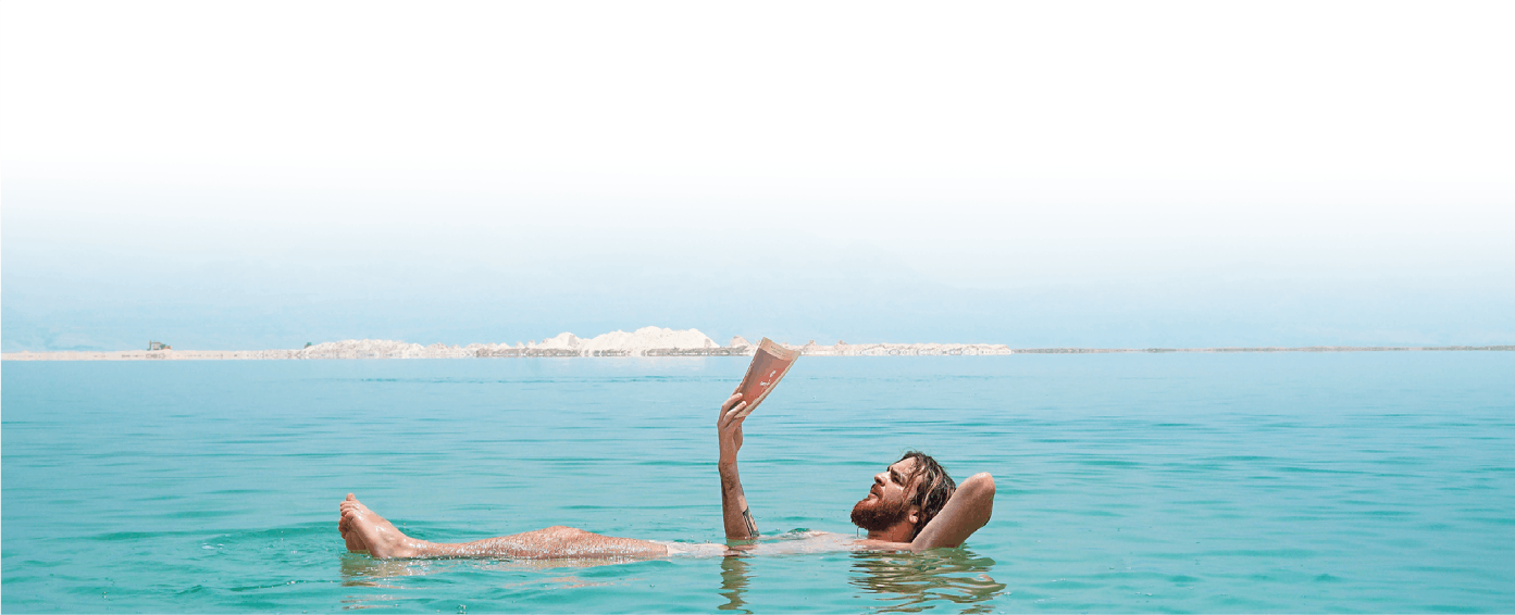 Man reading in ocean