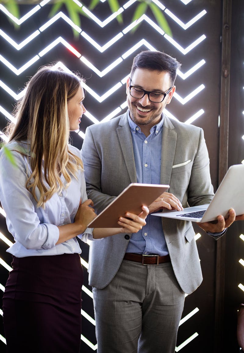 2 Investors looking at their investments on their laptops