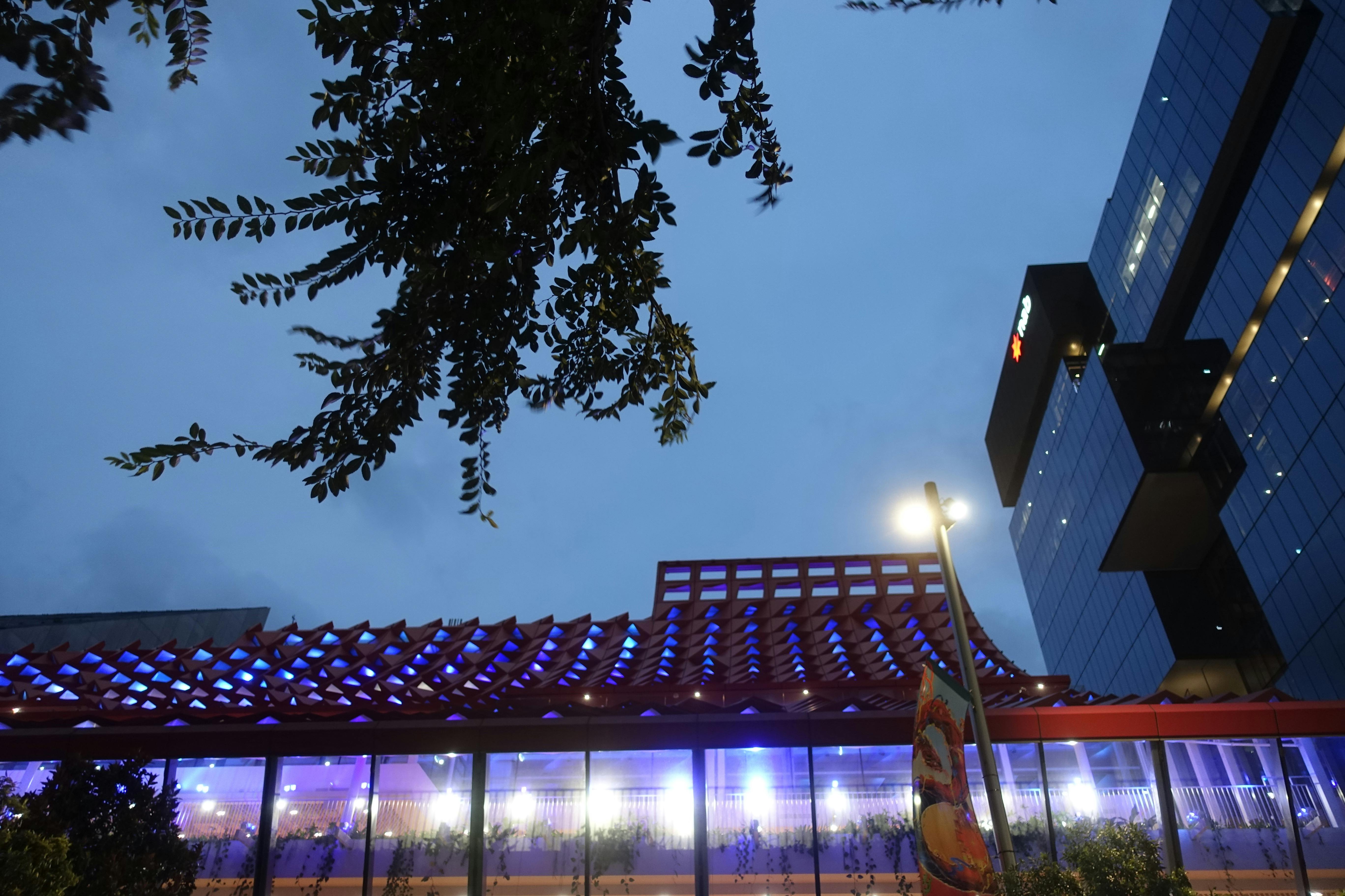 Rooftop of the PHIVE building in Parramatta with a wave-like pattern, illuminated at night. 