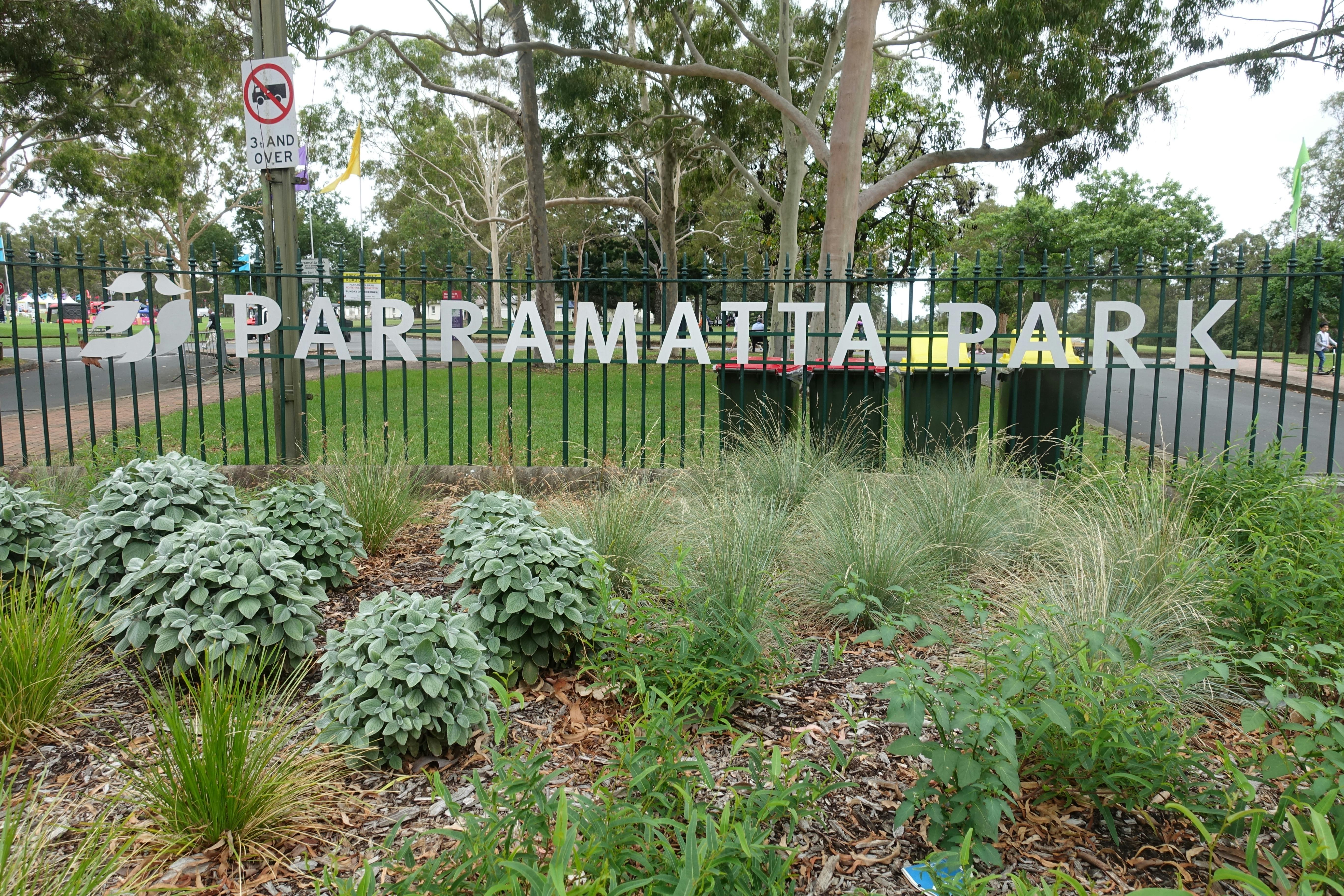 A park fence with a sign that reads ‘Parramatta Park’.  