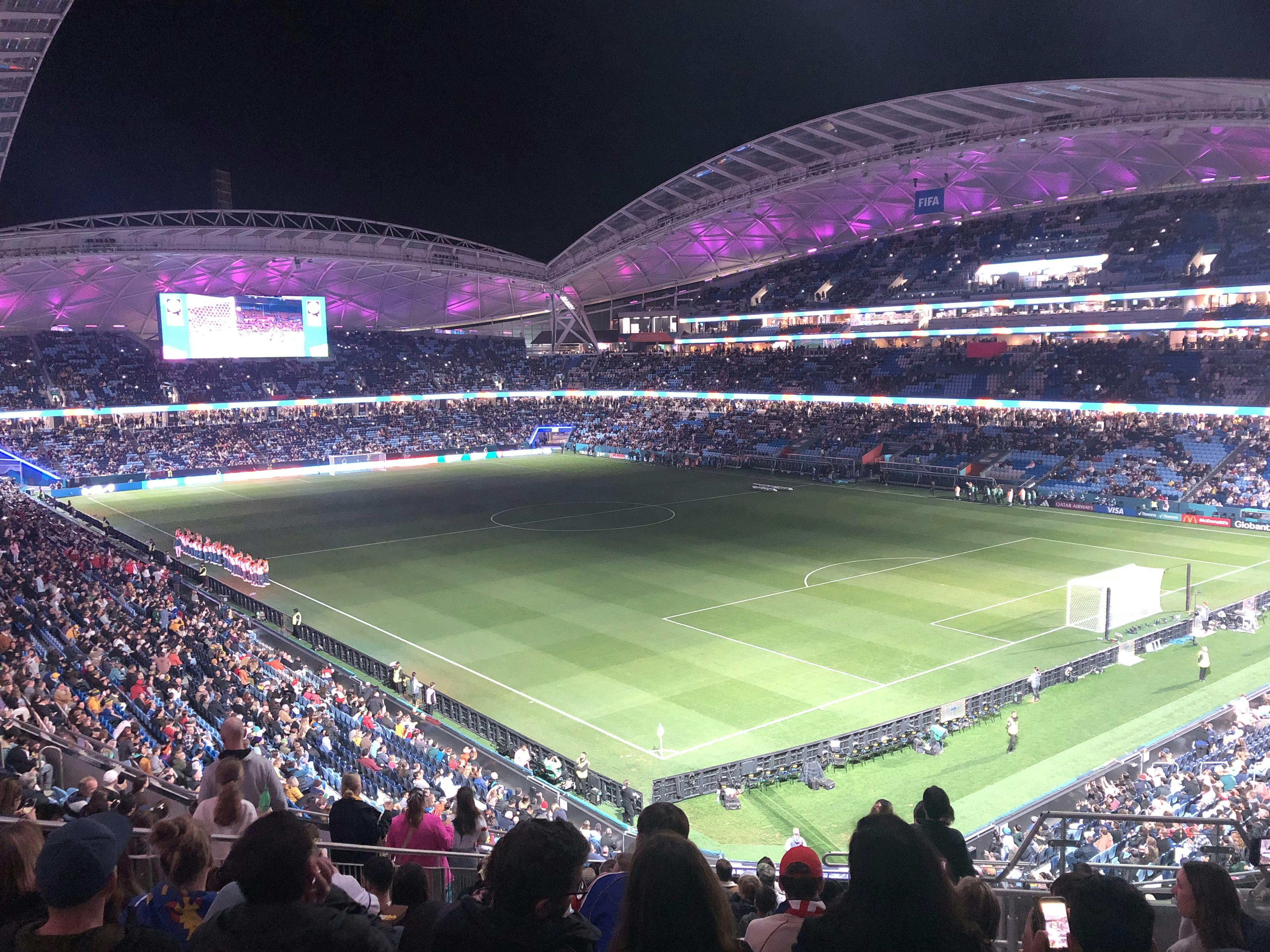 A football stadium filled with seated patrons waiting for the game a begin.  