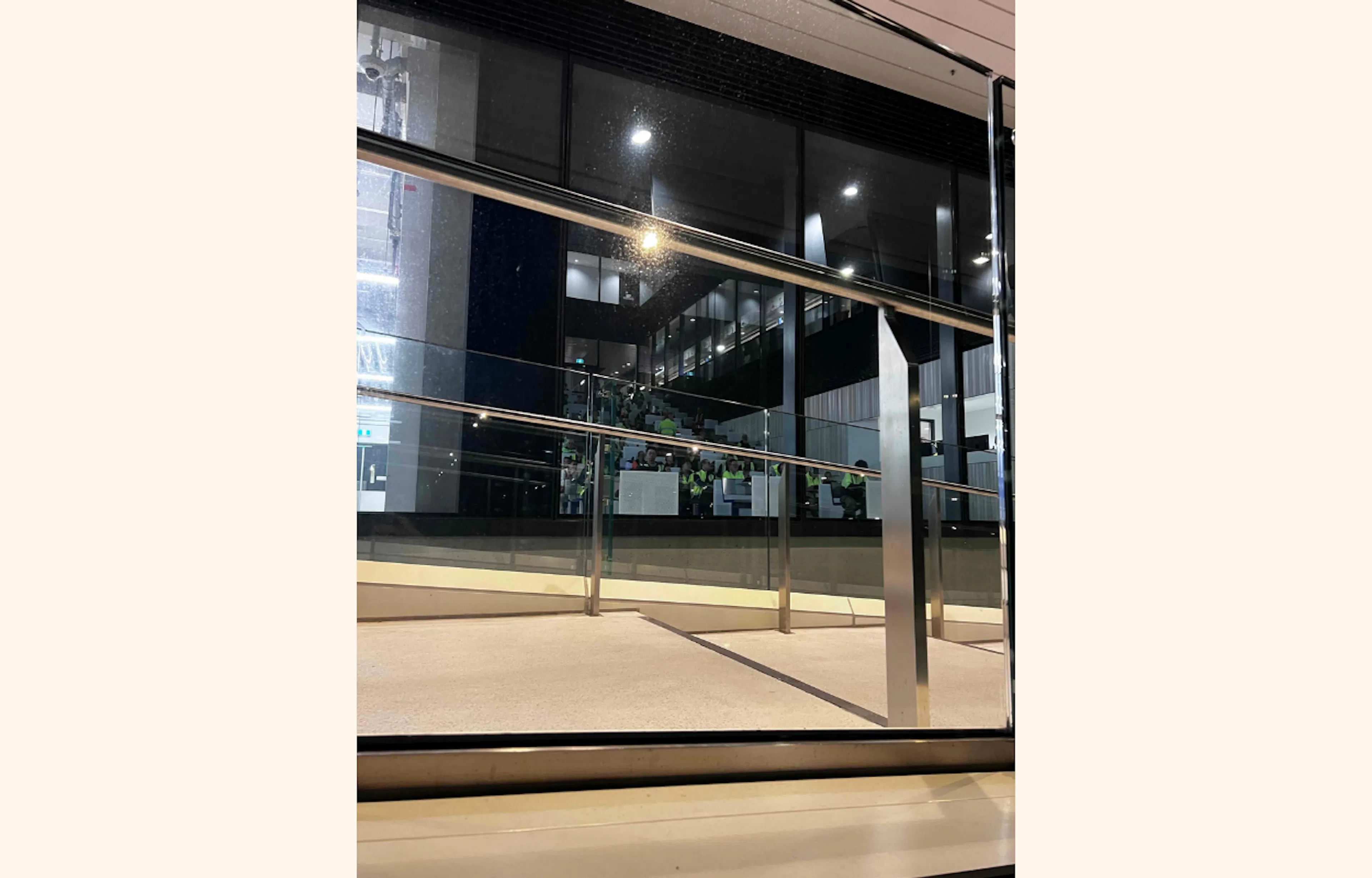 Phone photograph of glass and railings along western entrance of Sydney Fish Market.