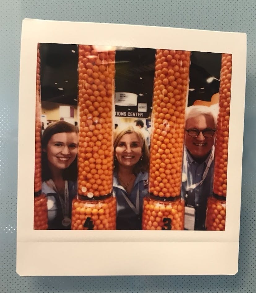 Elizabeth, Cathy and Tom at a Symmetry conference booth