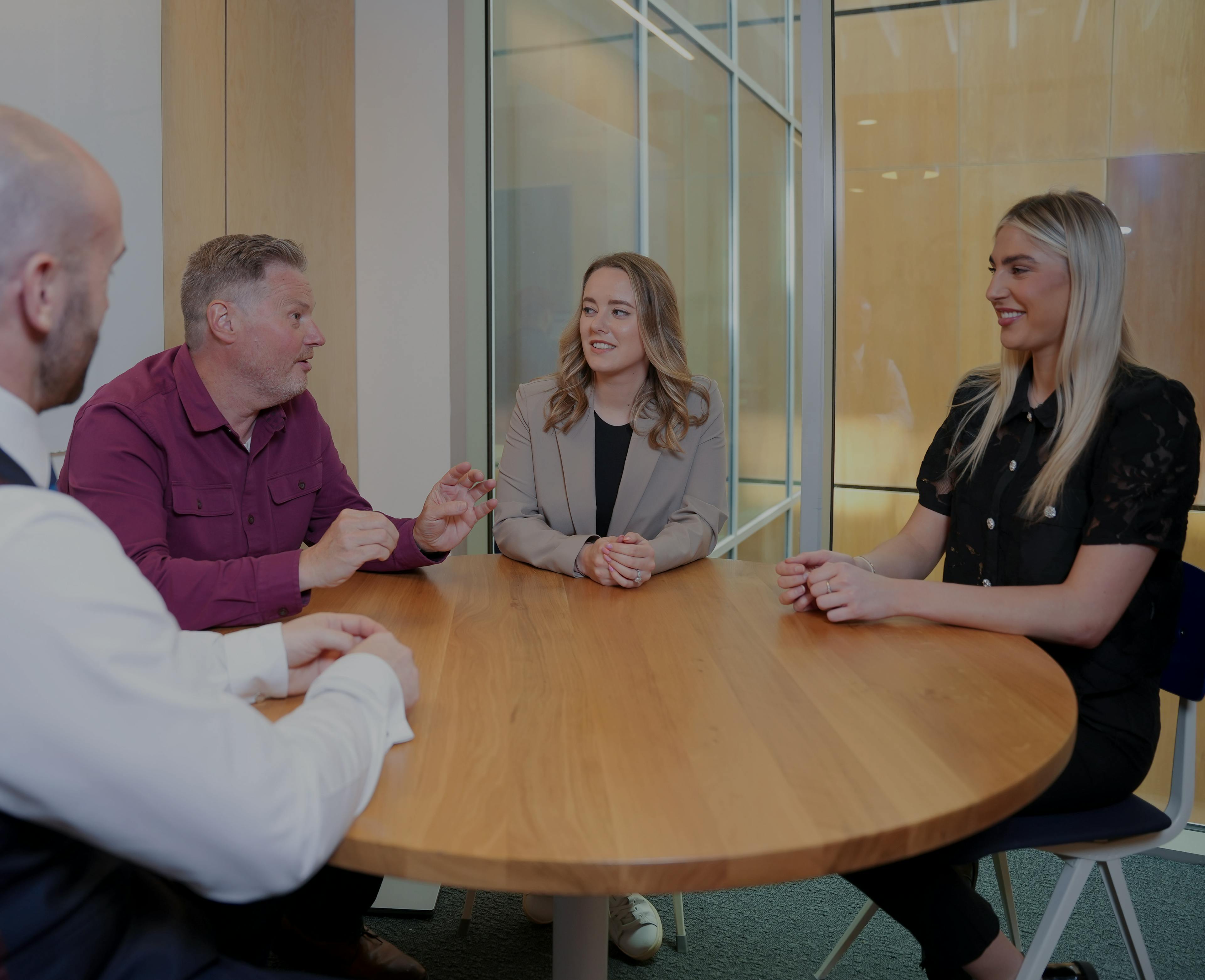 Three seniors and one employee laughing 