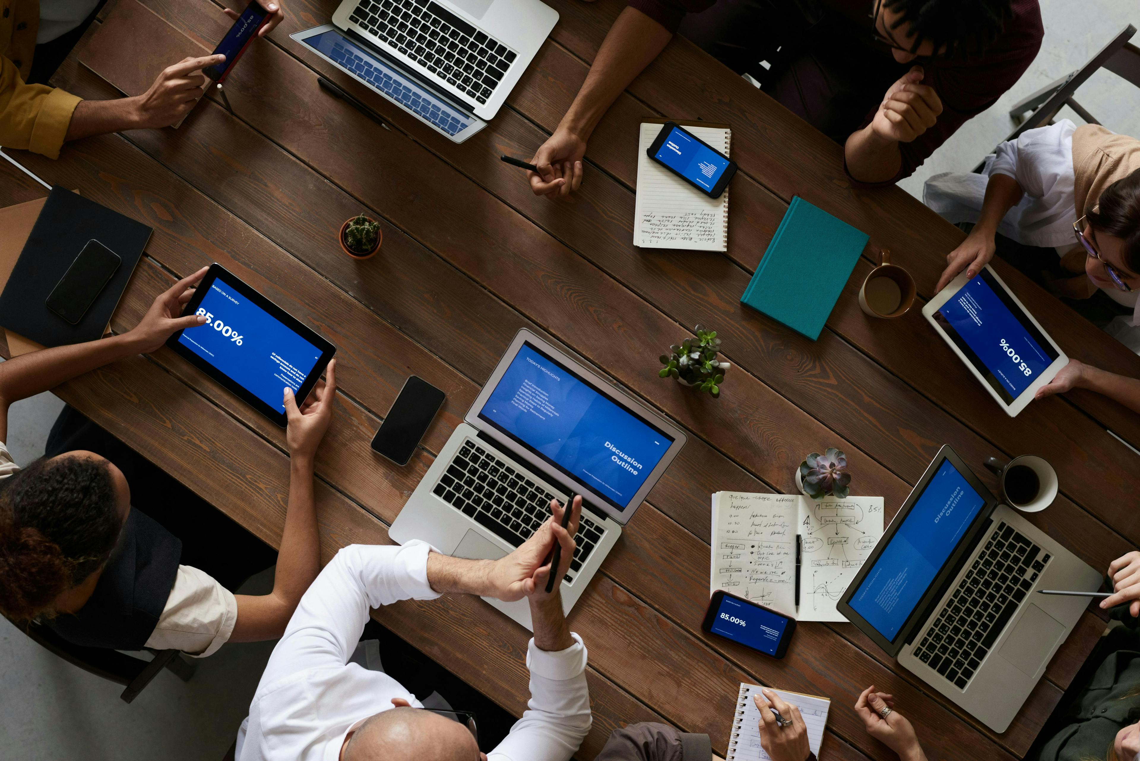 Image of people sat round at desk